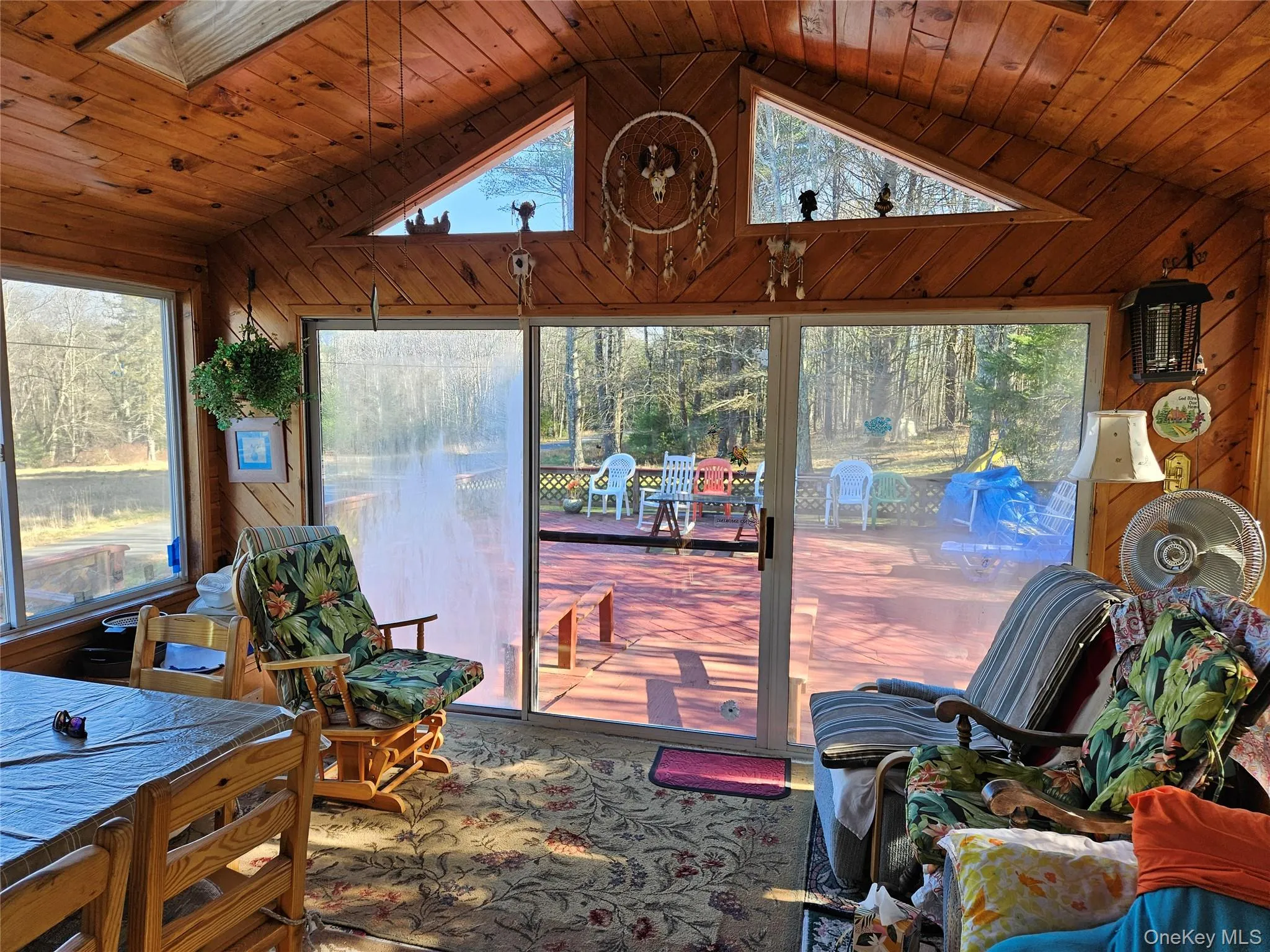 Sunroom featuring lofted ceiling and a skylight Sunroom featuring lofted ceiling and a skylight