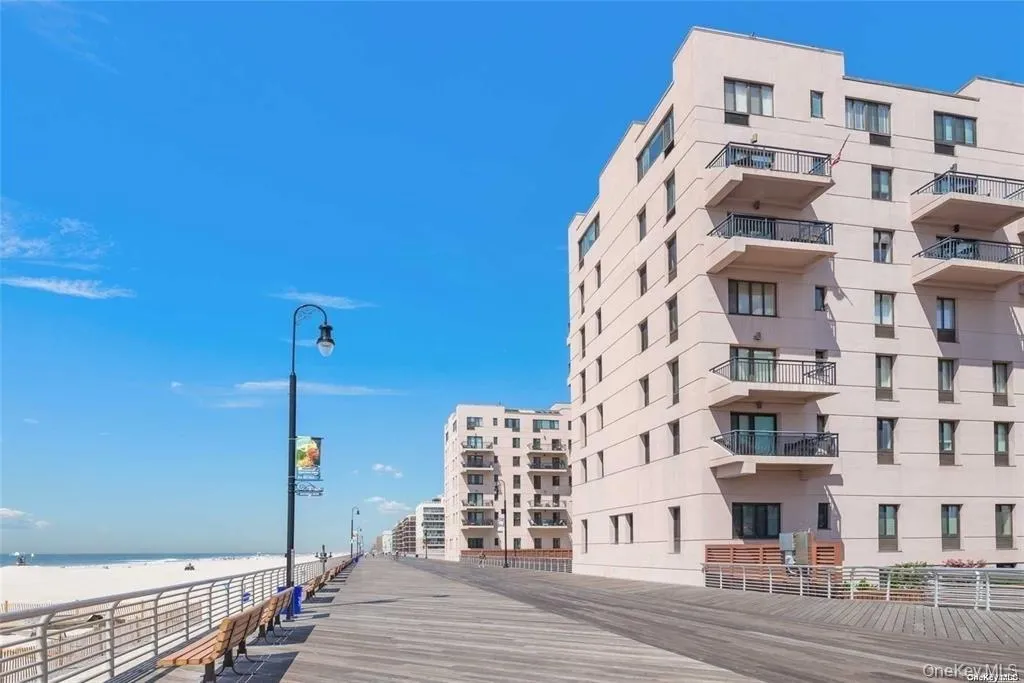 View of apartment building / complex featuring view of water and beach View of apartment building / complex featuring view of water and beach
