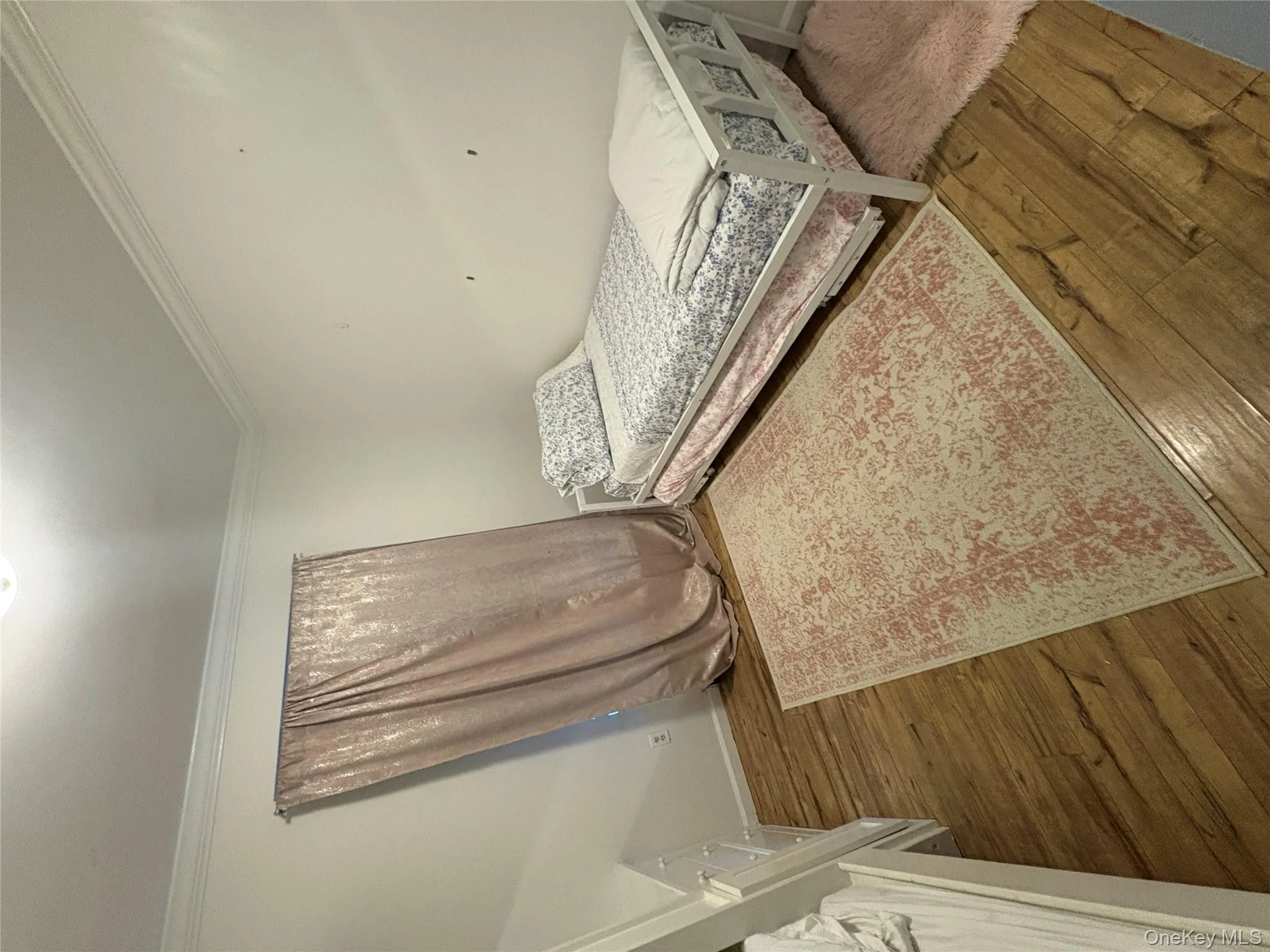 Bedroom with wood-type flooring and crown molding Bedroom with wood-type flooring and crown molding