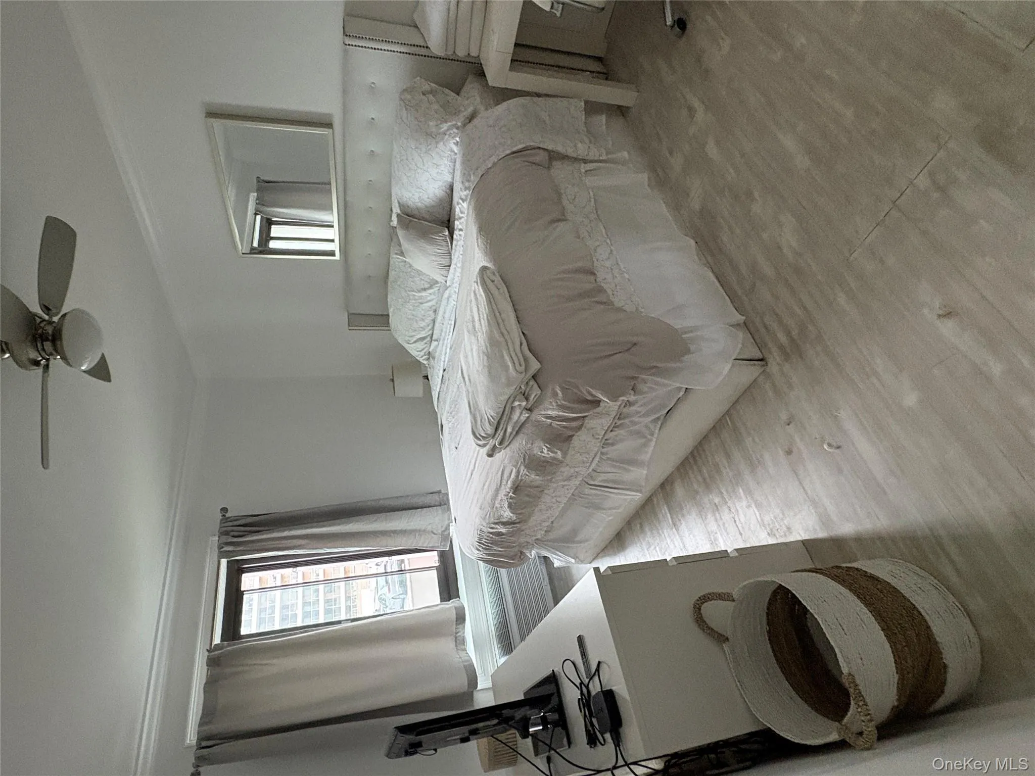 Bedroom featuring wood finished floors, ornamental molding, and ceiling fan Bedroom featuring wood finished floors, ornamental molding, and ceiling fan