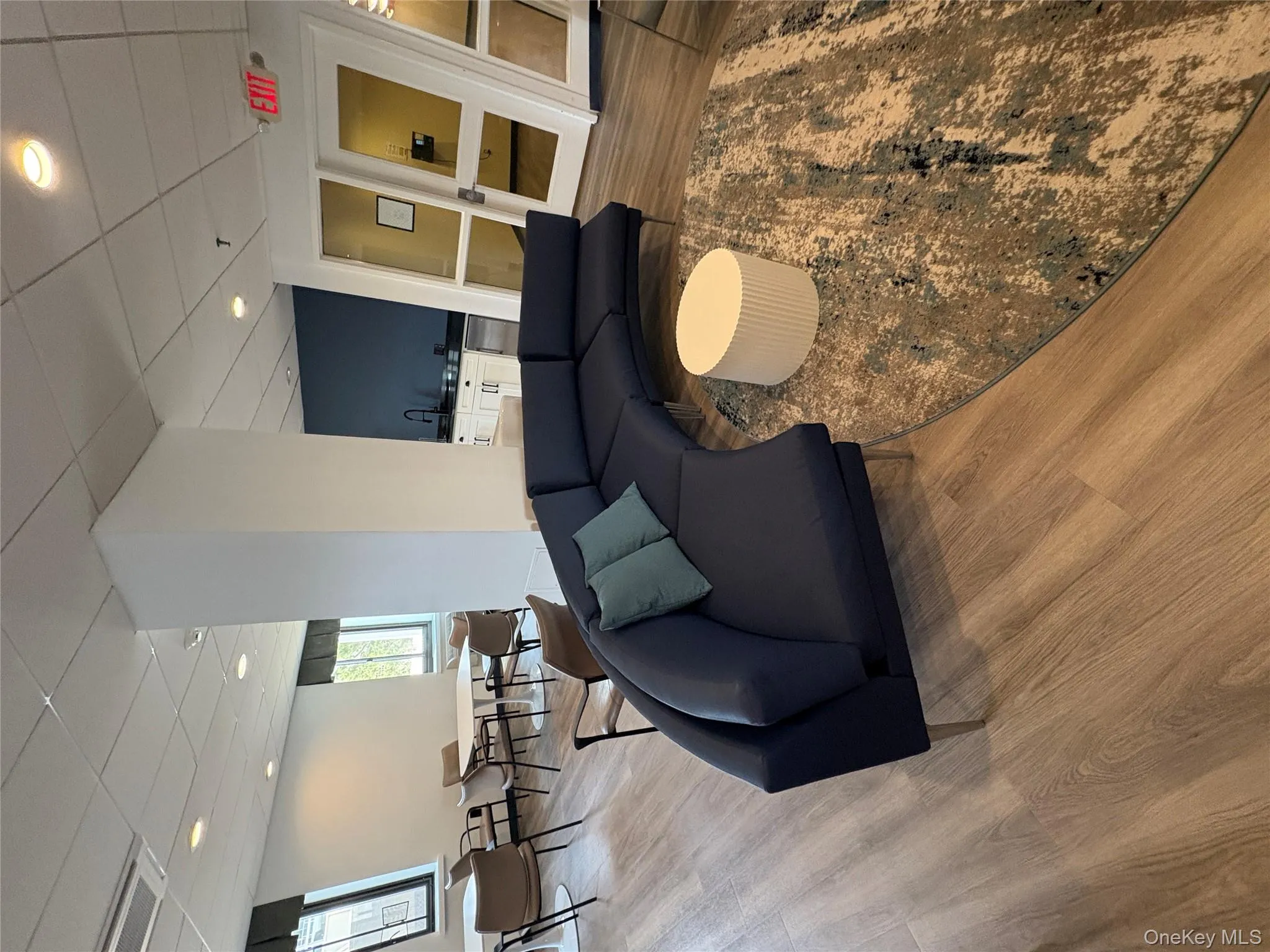 Living area with a drop ceiling, light wood-type flooring, and recessed lighting Living area with a drop ceiling, light wood-type flooring, and recessed lighting