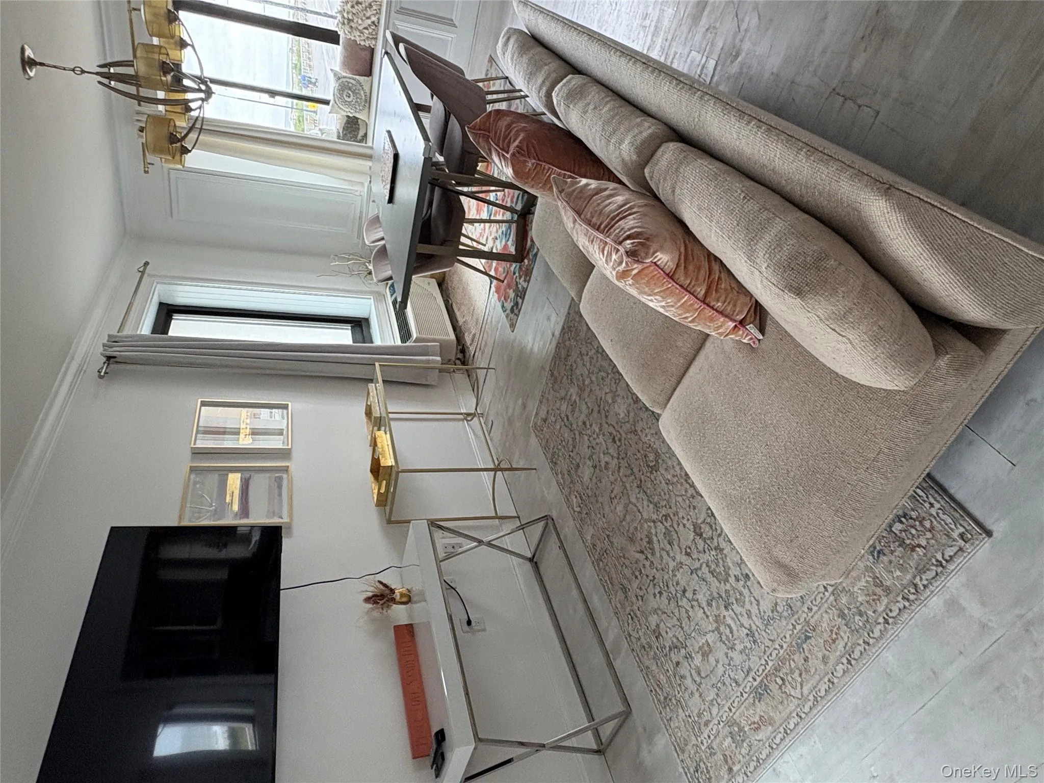 Living area with crown molding, a chandelier, and hardwood / wood-style floors Living area with crown molding, a chandelier, and hardwood / wood-style floors