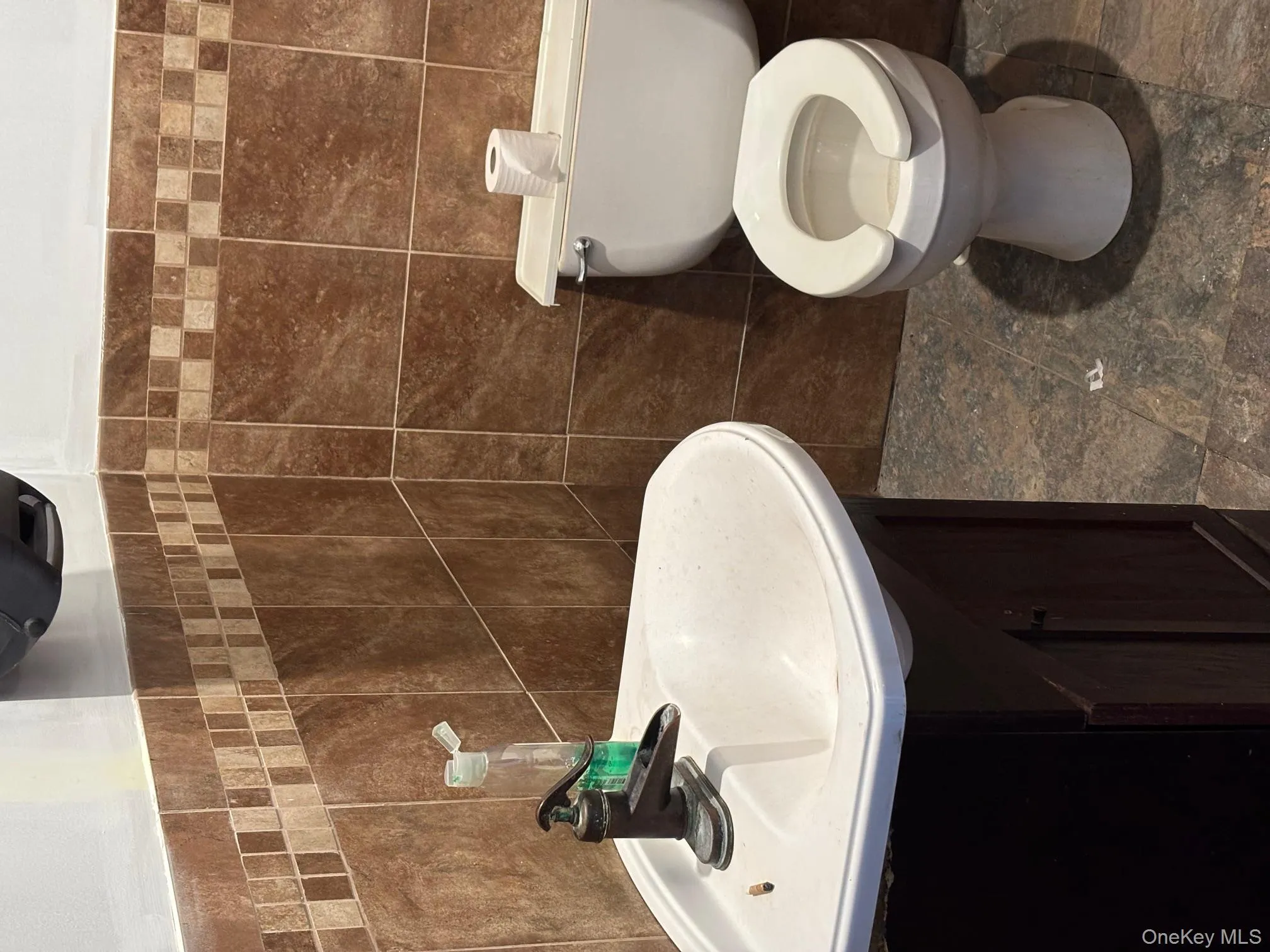 Half bathroom featuring vanity and tile walls Half bathroom featuring vanity and tile walls