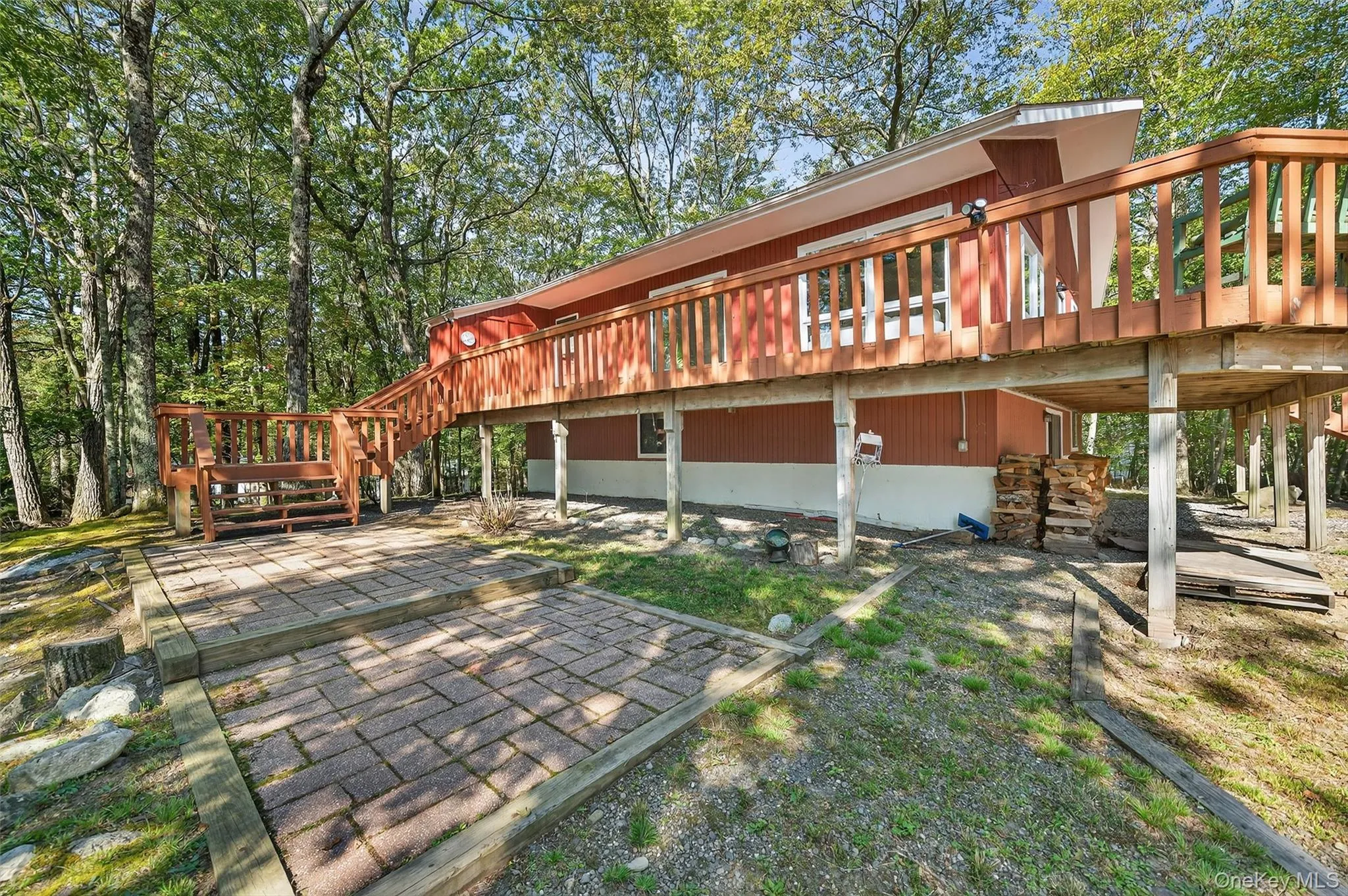 Rear view of property featuring a wooden deck, stairs, and a patio area Rear view of property featuring a wooden deck, stairs, and a patio area