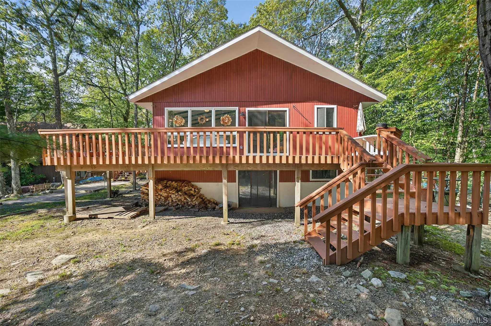 Rear view of property featuring a wooden deck and stairway Rear view of property featuring a wooden deck and stairway