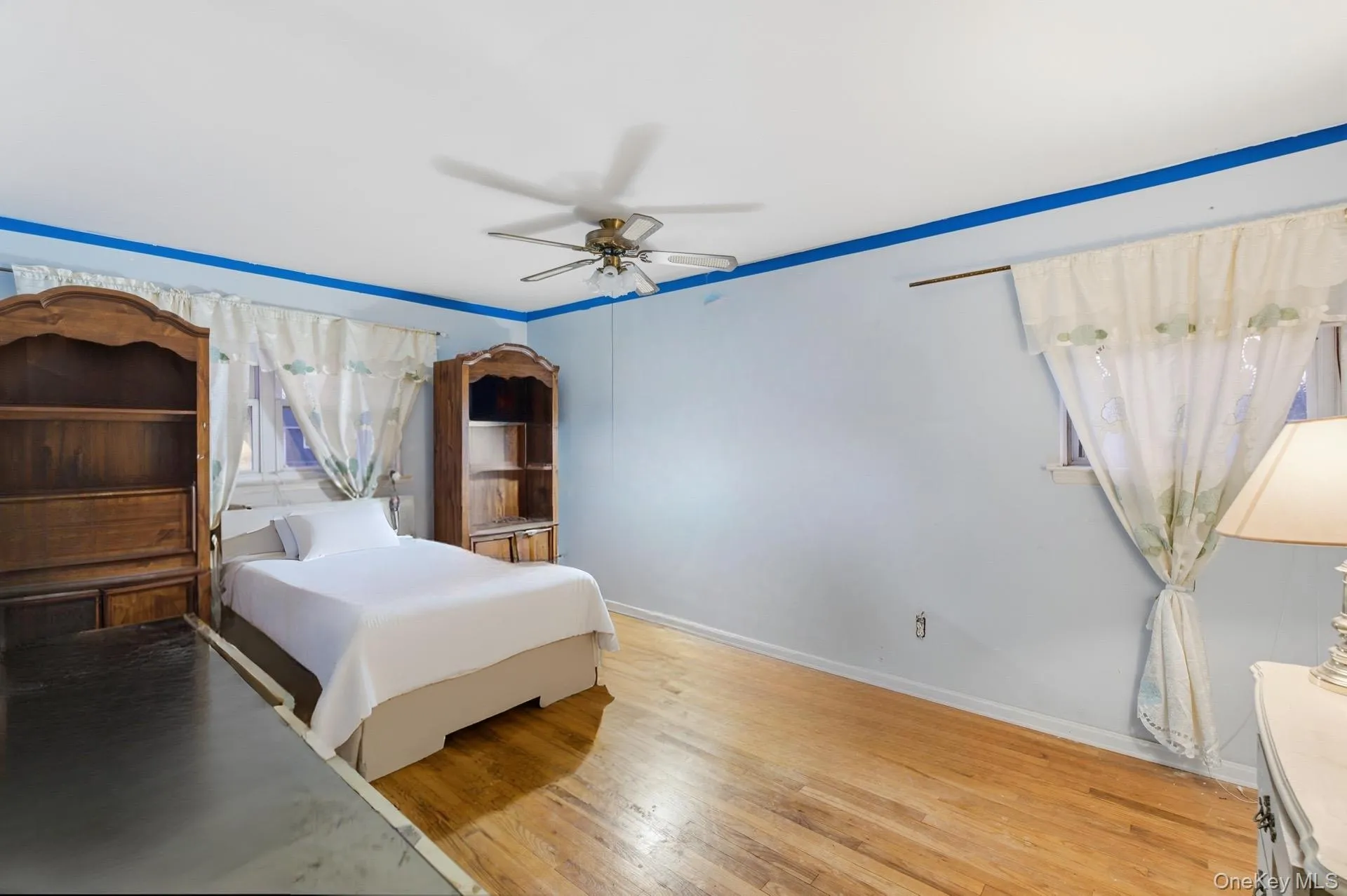 Bedroom with ceiling fan and light wood finished floors Bedroom with ceiling fan and light wood finished floors