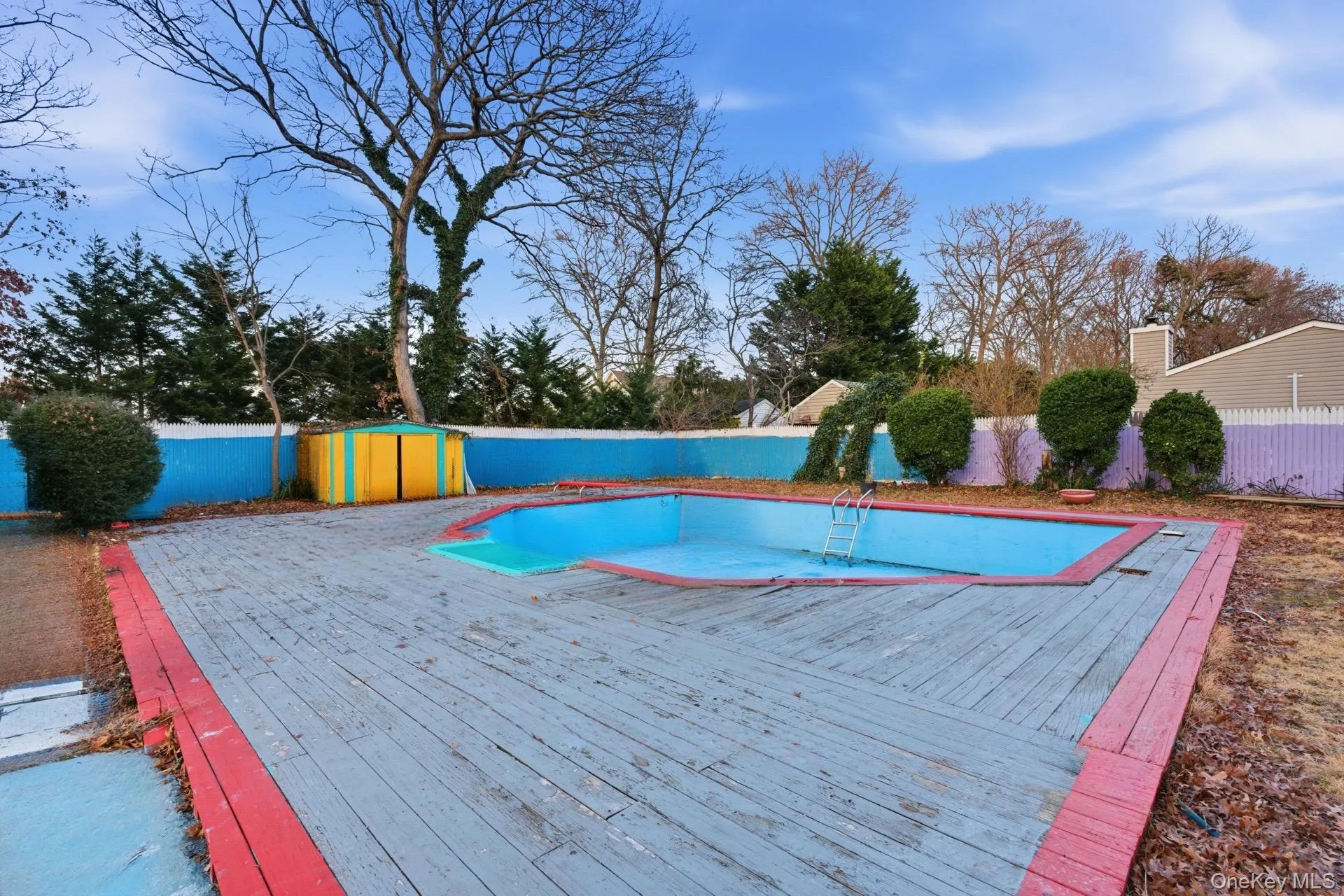 View of swimming pool with a fenced backyard and a deck View of swimming pool with a fenced backyard and a deck