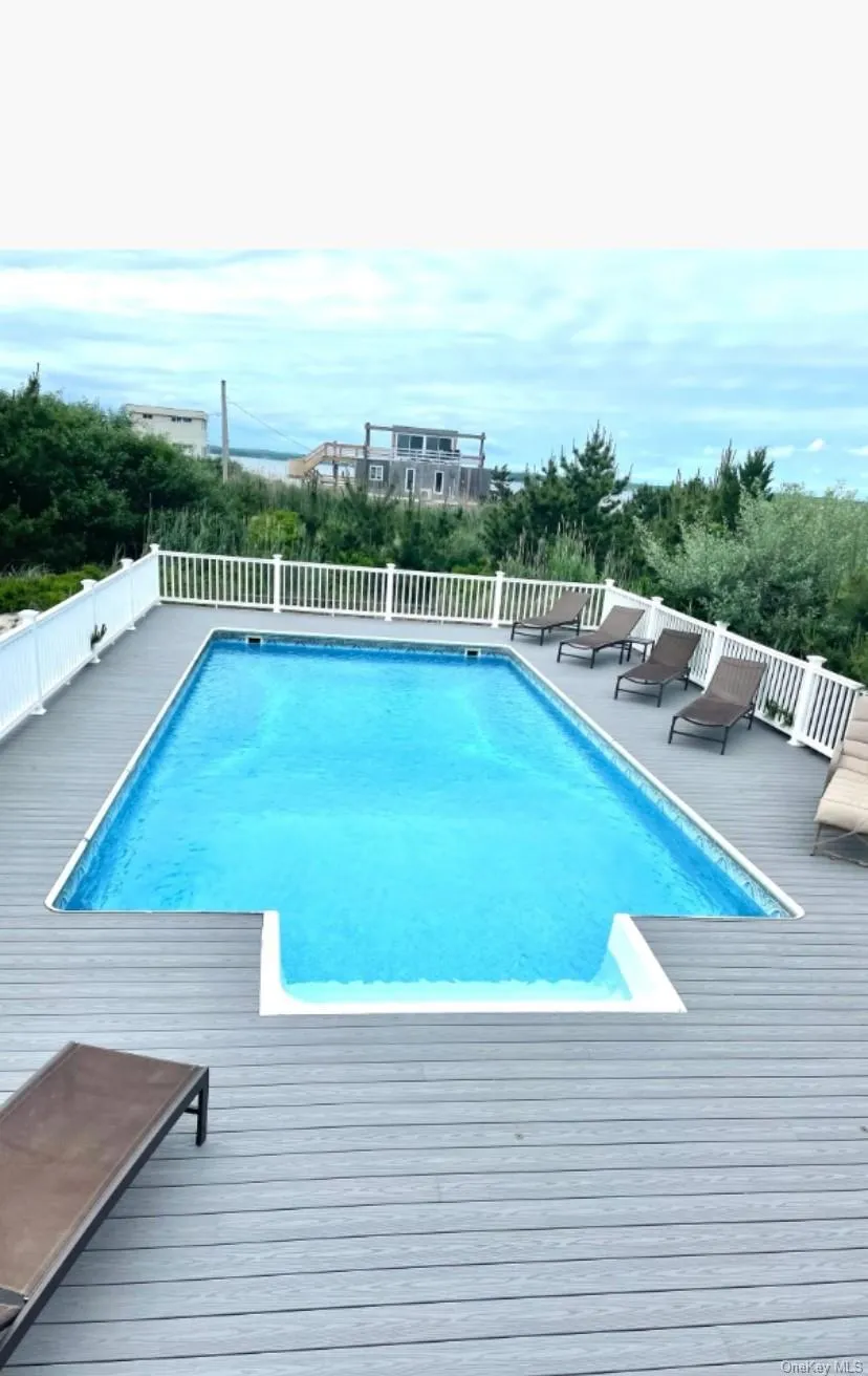 View of swimming pool with a wooden deck View of swimming pool with a wooden deck