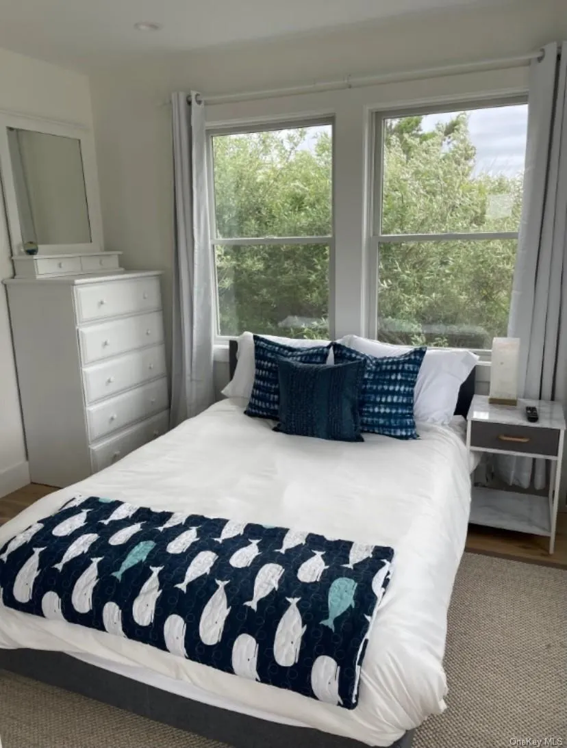 Bedroom featuring wood finished floors Bedroom featuring wood finished floors