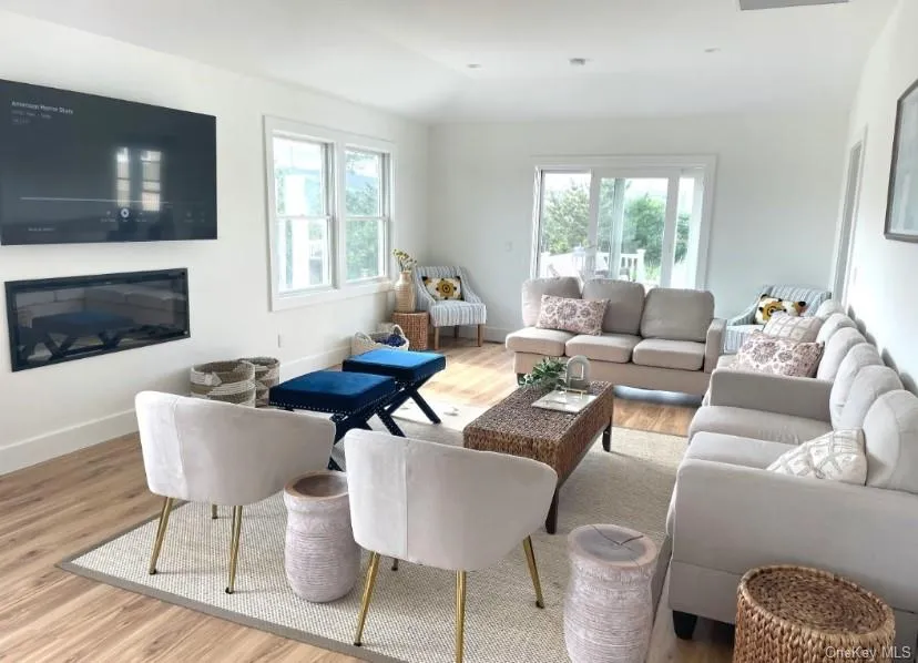 Living room featuring light wood finished floors and baseboards Living room featuring light wood finished floors and baseboards