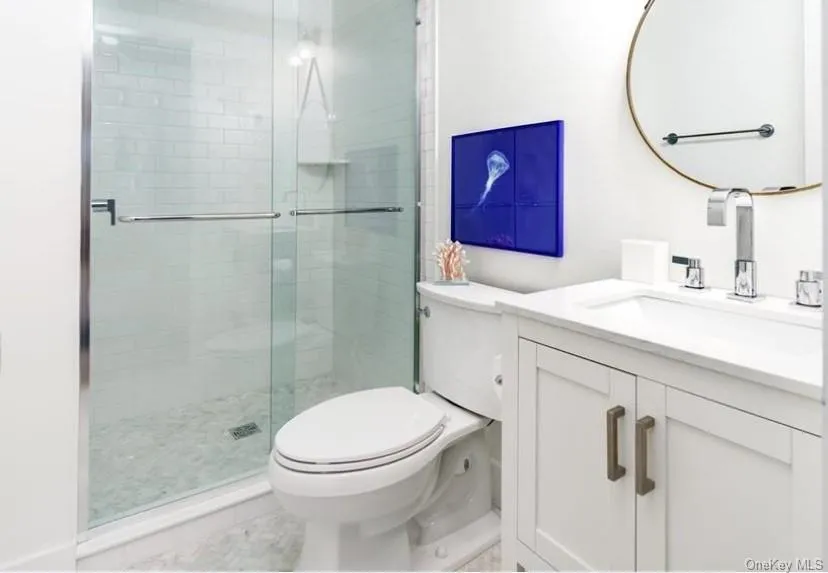 Bathroom featuring vanity and a shower stall Bathroom featuring vanity and a shower stall