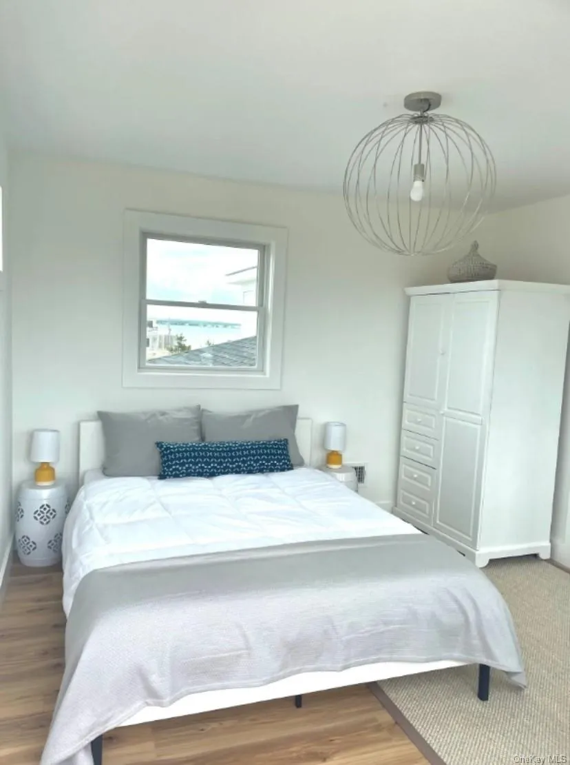 Bedroom featuring wood finished floors Bedroom featuring wood finished floors
