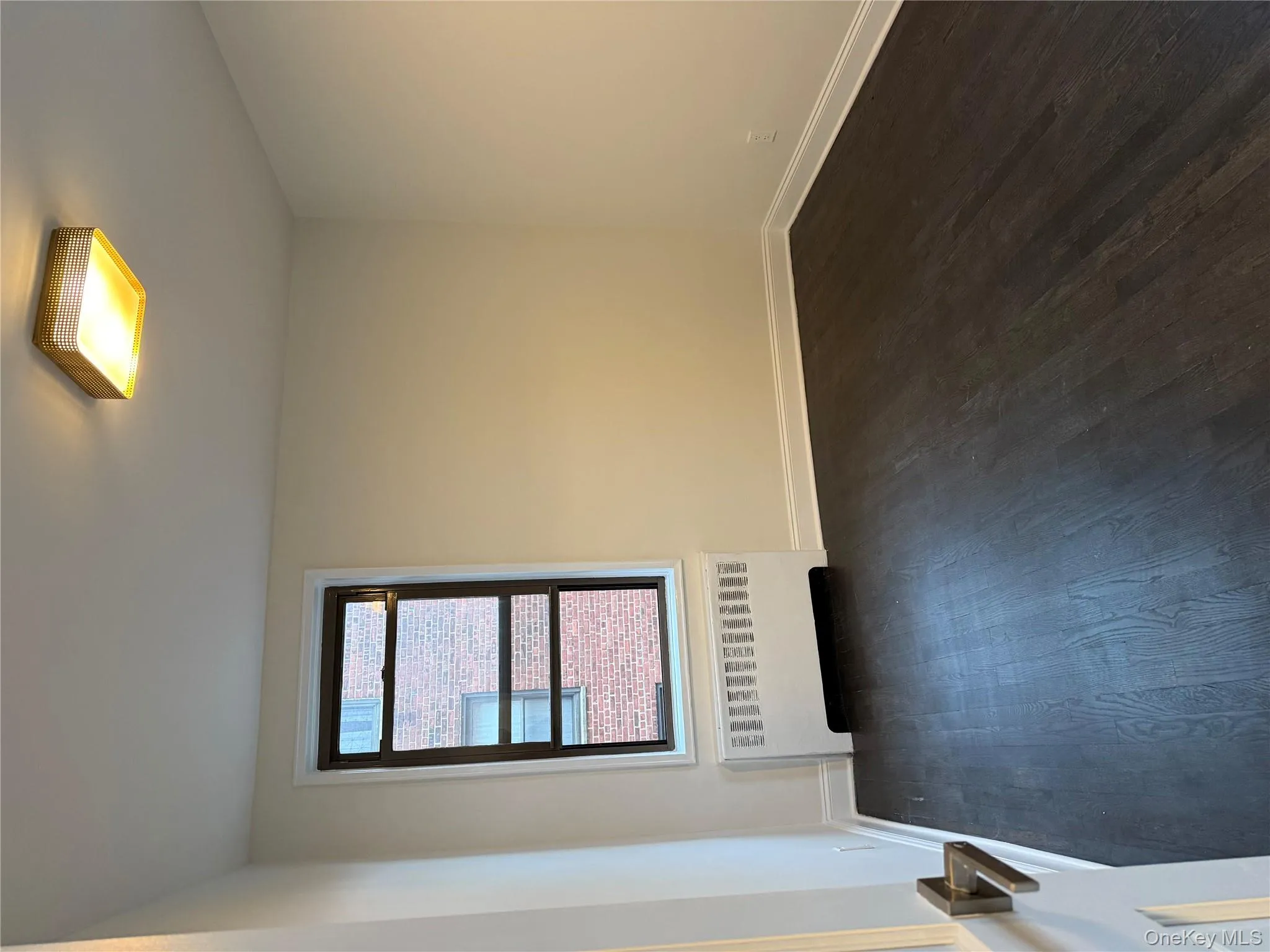 Empty room featuring dark wood finished floors and radiator Empty room featuring dark wood finished floors and radiator