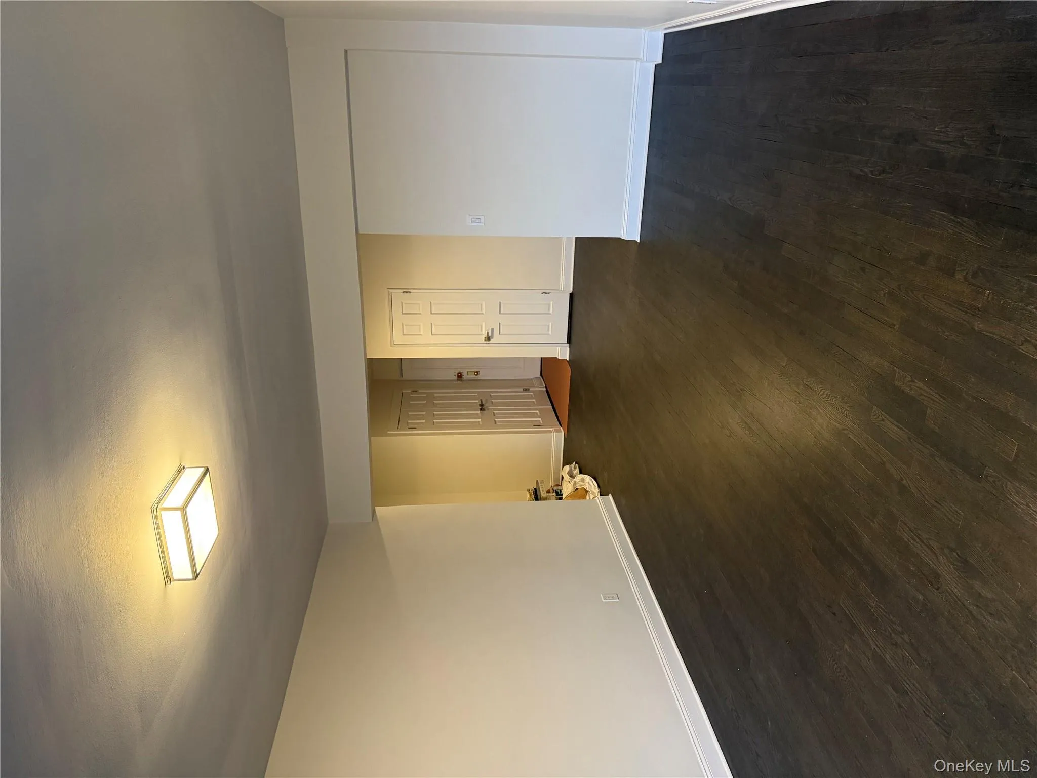 Unfurnished room with dark wood-type flooring and baseboards Unfurnished room with dark wood-type flooring and baseboards