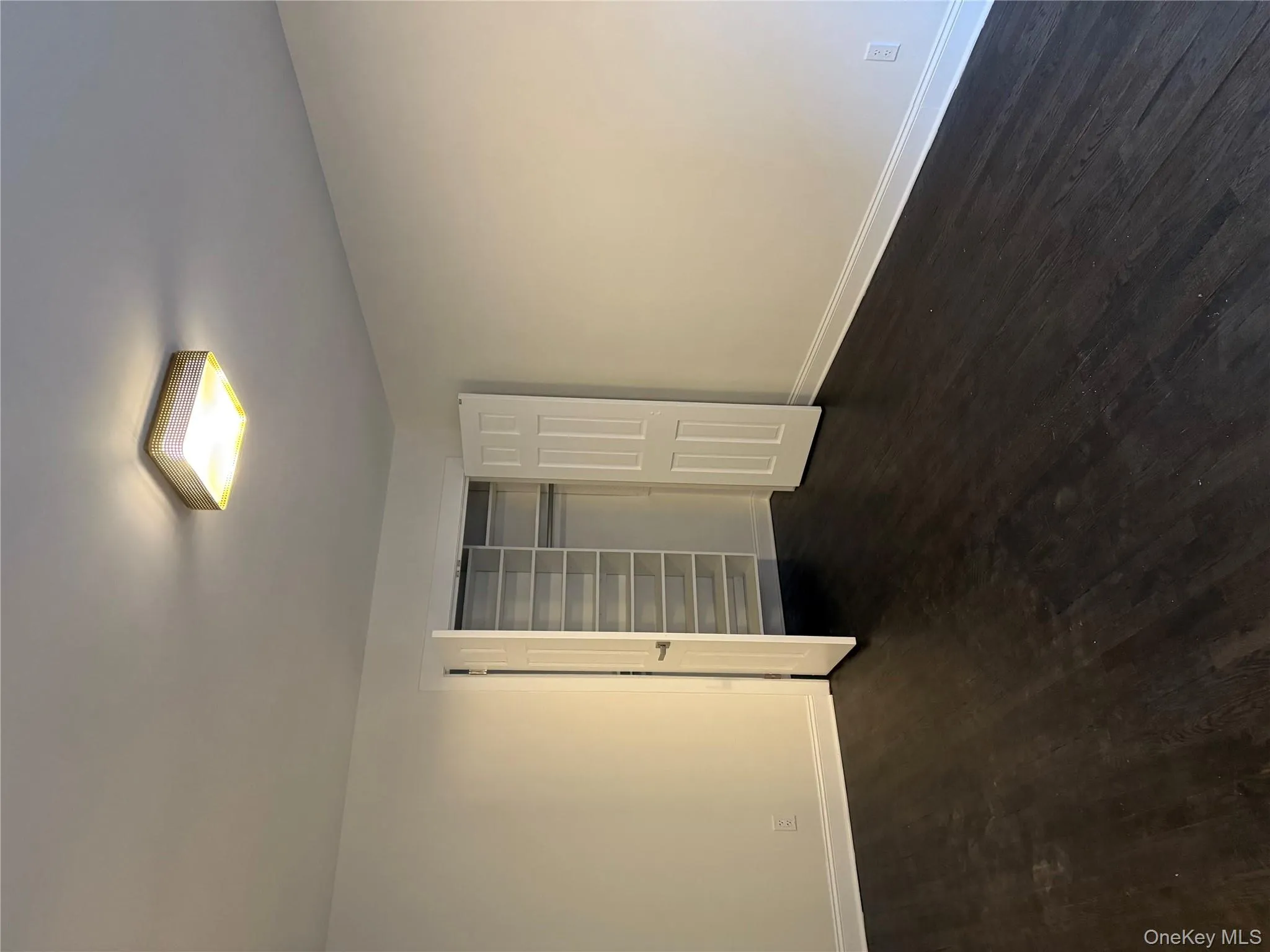 Unfurnished bedroom featuring dark wood finished floors and a closet Unfurnished bedroom featuring dark wood finished floors and a closet