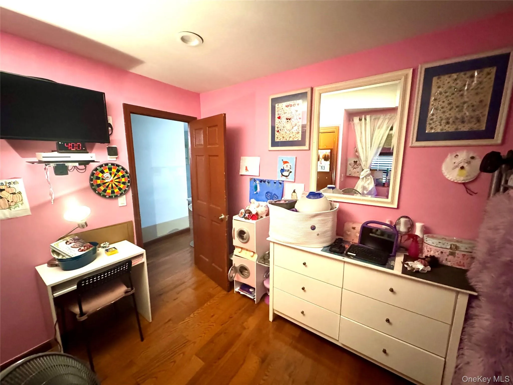 Bedroom featuring dark wood finished floors Bedroom featuring dark wood finished floors