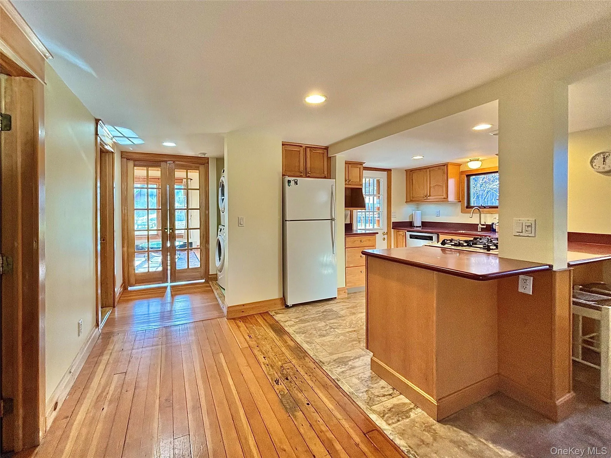 Kitchen with breakfast bar and French doors to the family room. Kitchen with breakfast bar and French doors to the family room.