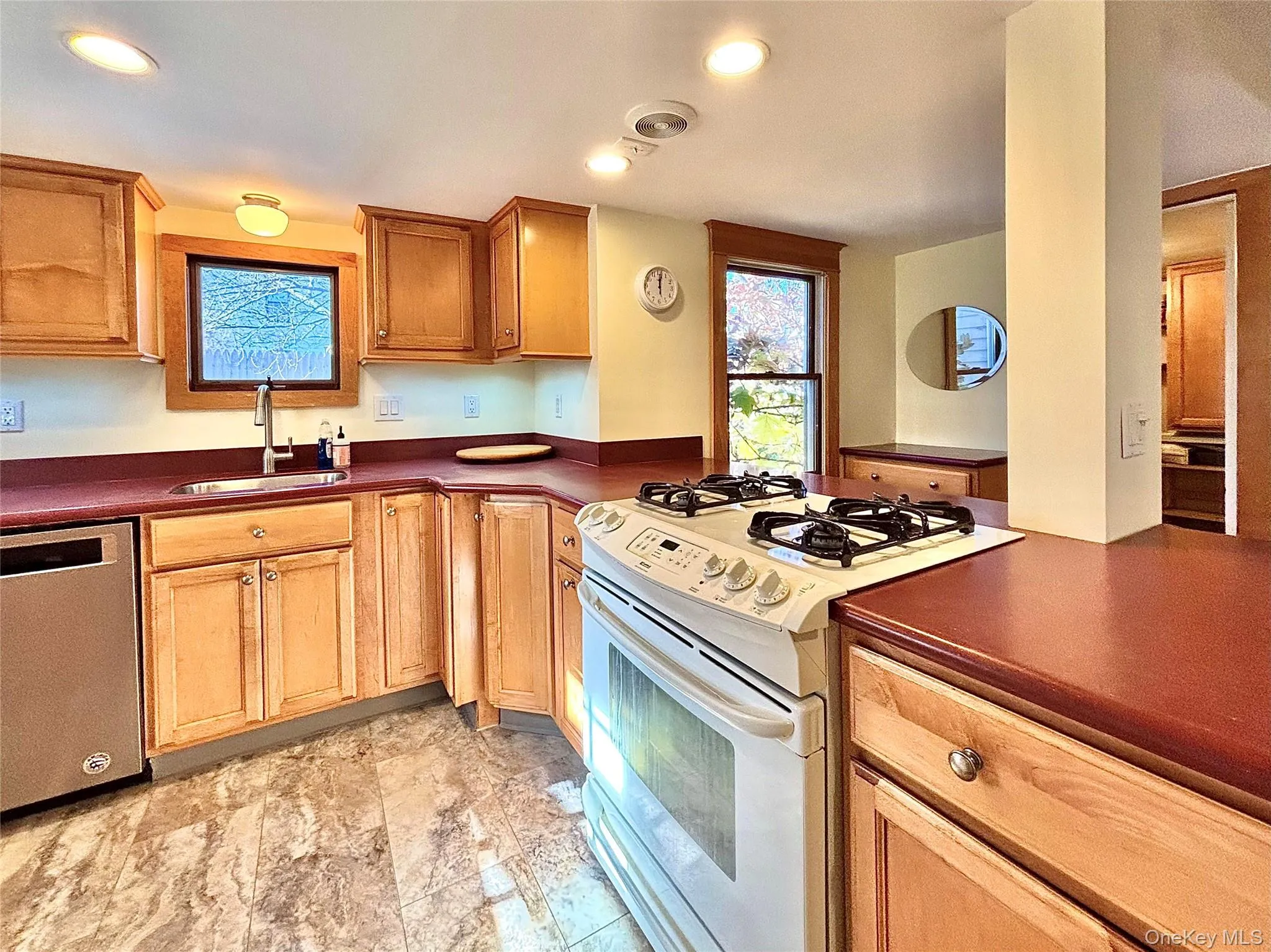Kitchen with Corian countertops and light wood cabinets Kitchen with Corian countertops and light wood cabinets