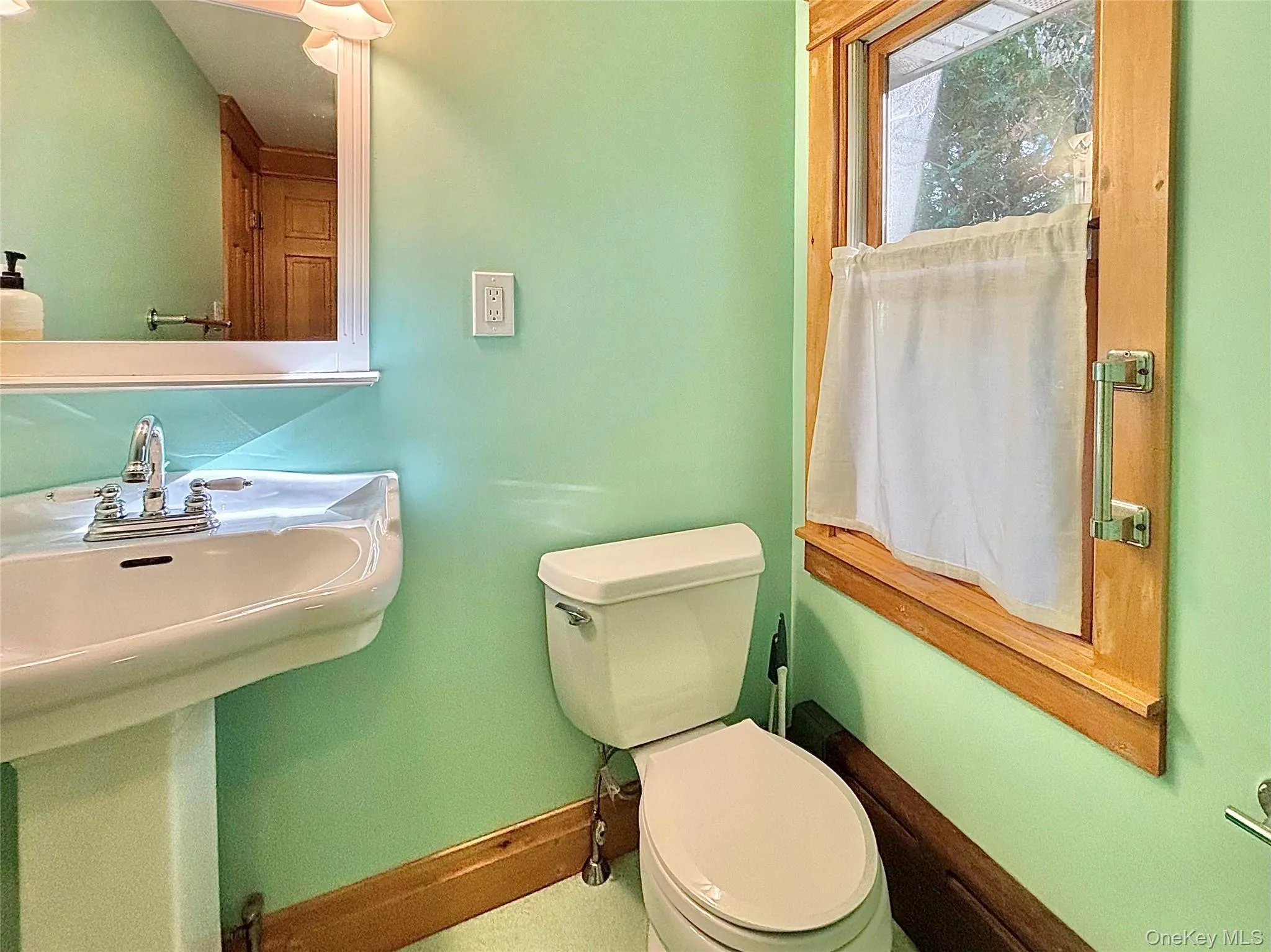 Bathroom with sink, commode and window Bathroom with sink, commode and window