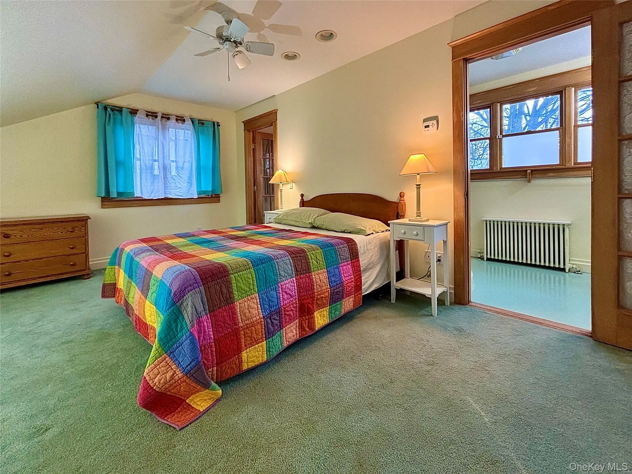 Primary Bedroom with a vaulted ceiling and ceiling fan Primary Bedroom with a vaulted ceiling and ceiling fan