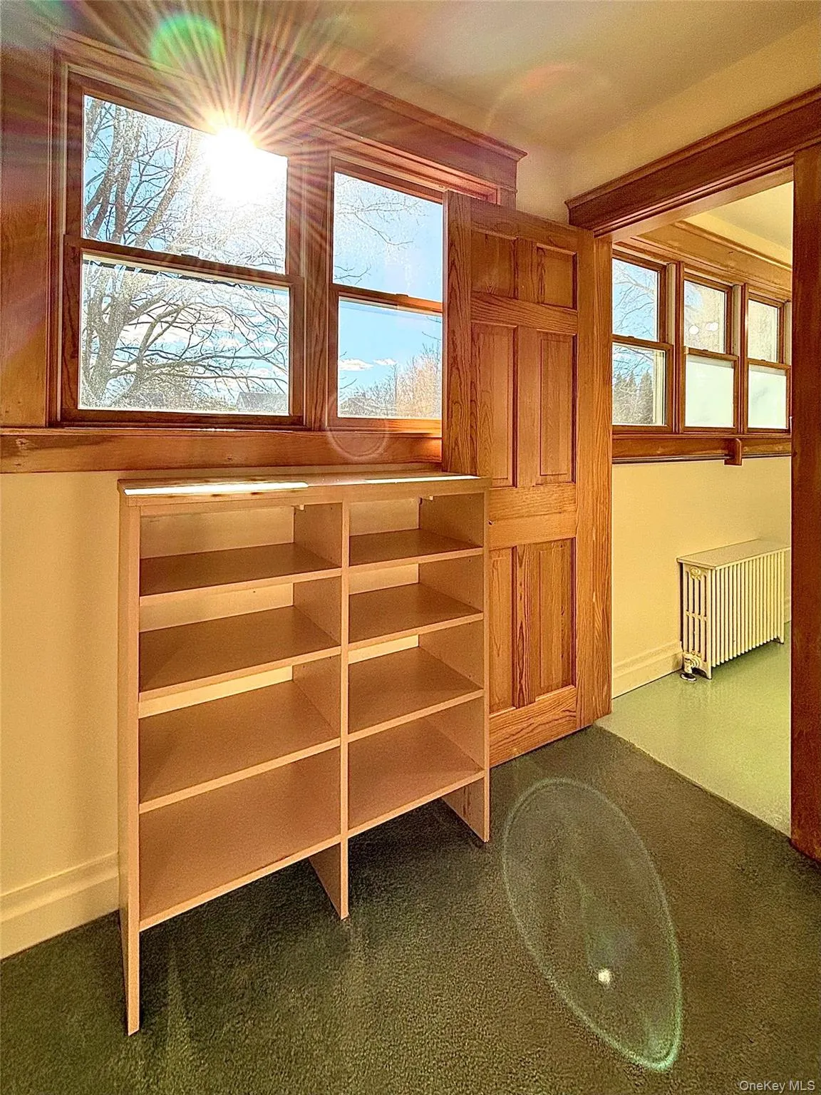 Walk-in closet with custom shelves and beautiful wood framed windows Walk-in closet with custom shelves and beautiful wood framed windows