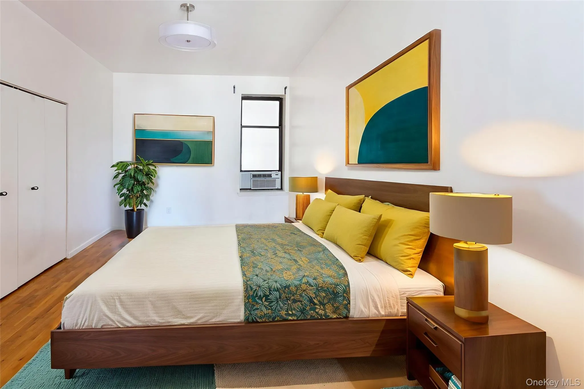 Bedroom featuring wood finished floors and a closet Bedroom featuring wood finished floors and a closet