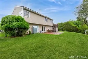 Back of house with a lawn and a patio area Back of house with a lawn and a patio area