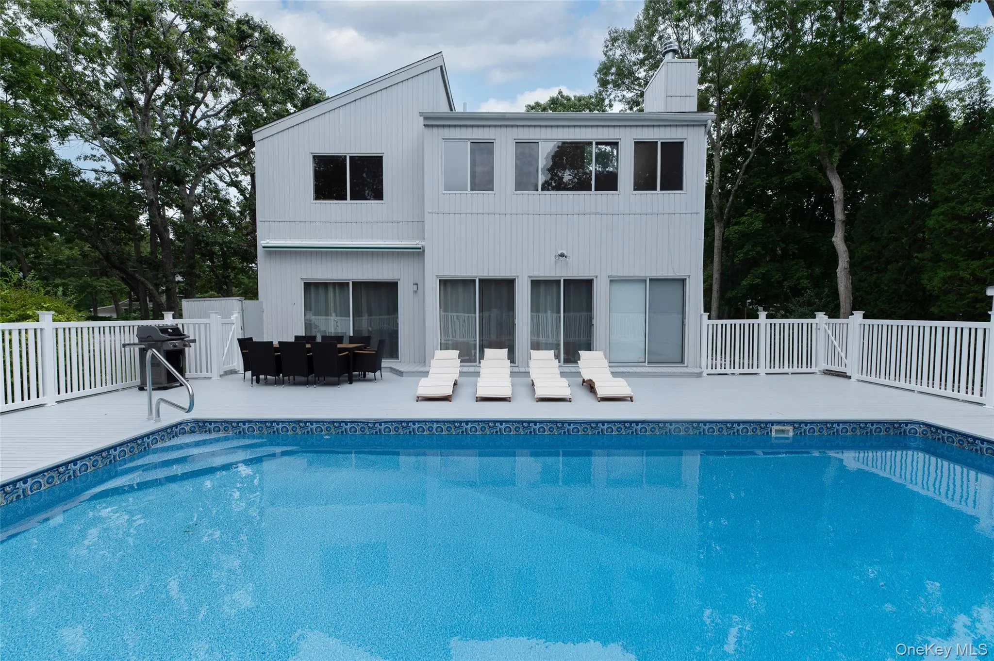 View of swimming pool featuring a fenced in pool, a patio area, outdoor dining area, and fence View of swimming pool featuring a fenced in pool, a patio area, outdoor dining area, and fence