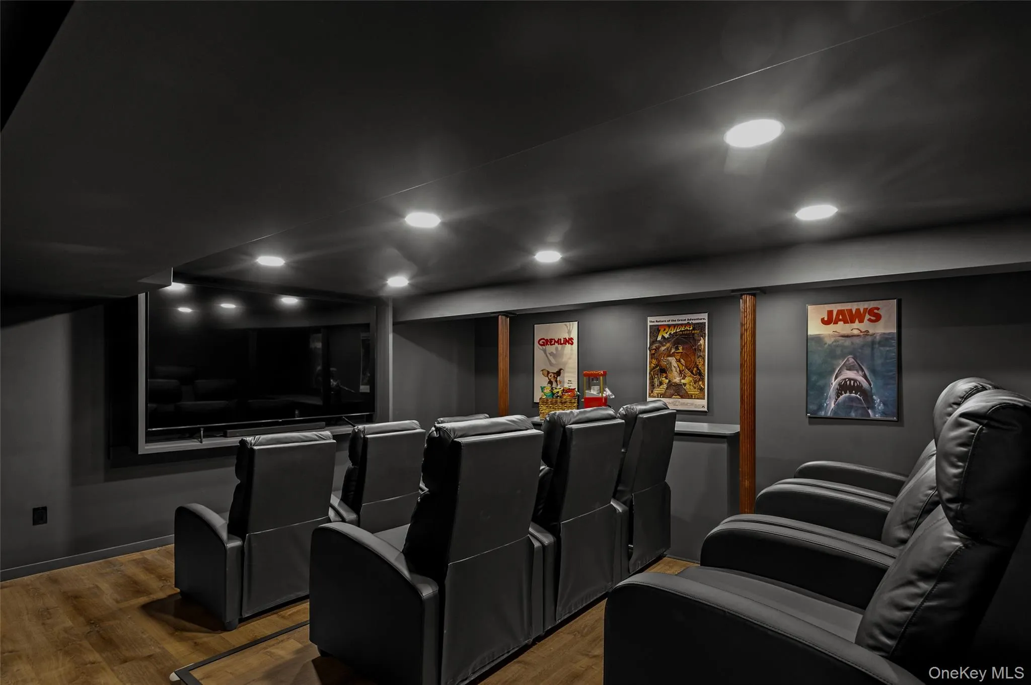 Home theater room featuring recessed lighting and wood finished floors Home theater room featuring recessed lighting and wood finished floors