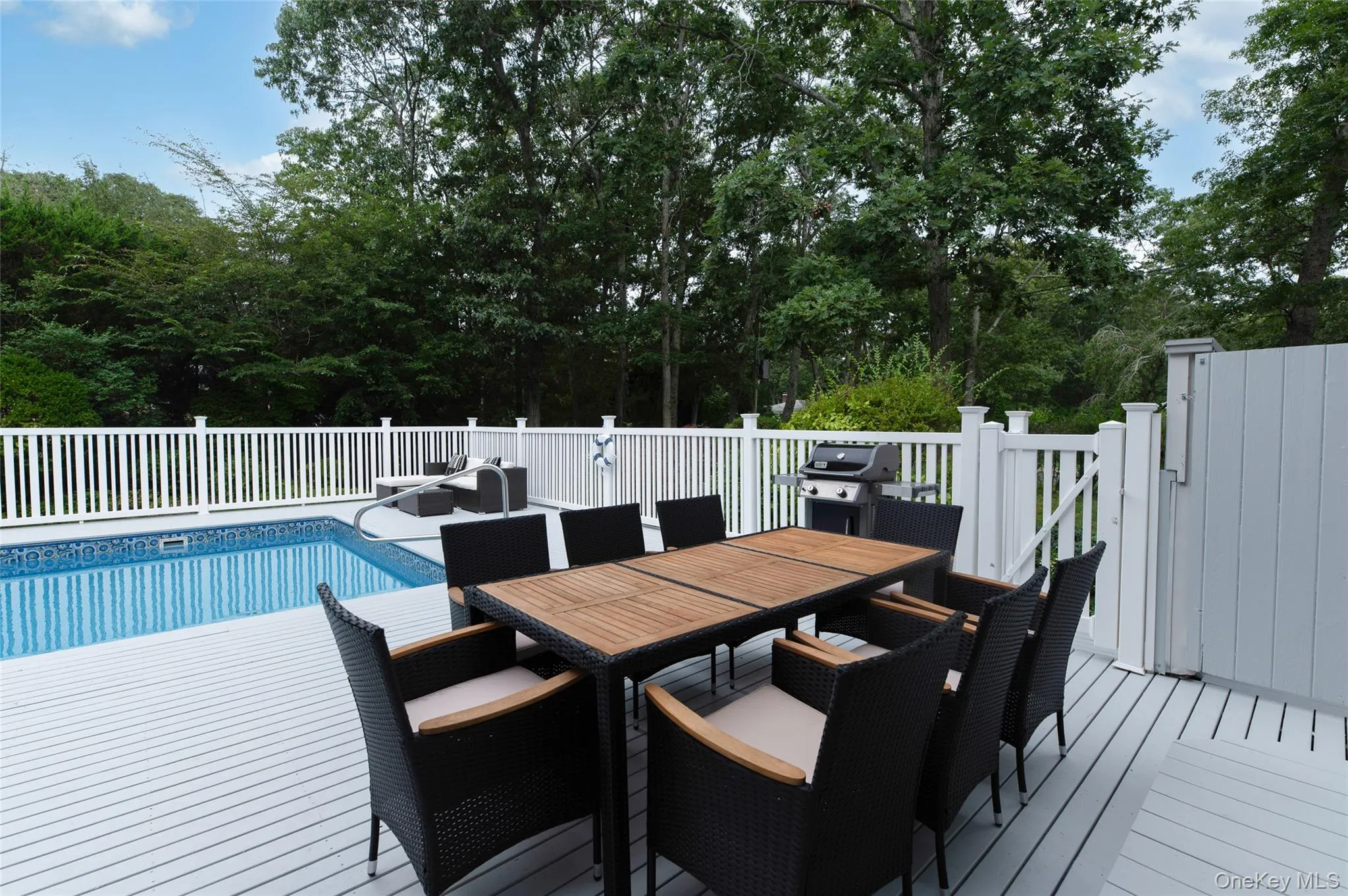 View of swimming pool featuring a grill, outdoor dining space, a fenced in pool, and a deck View of swimming pool featuring a grill, outdoor dining space, a fenced in pool, and a deck