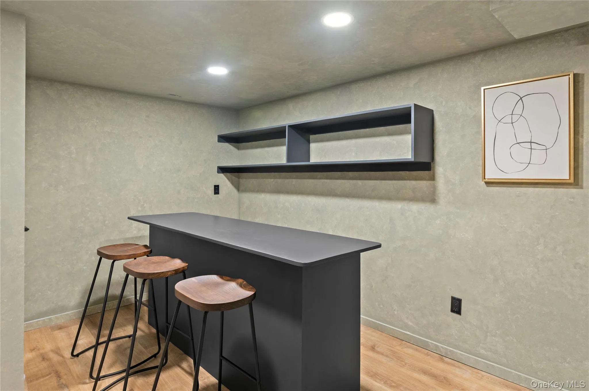 Bar with recessed lighting, light wood-style flooring, and baseboards Bar with recessed lighting, light wood-style flooring, and baseboards