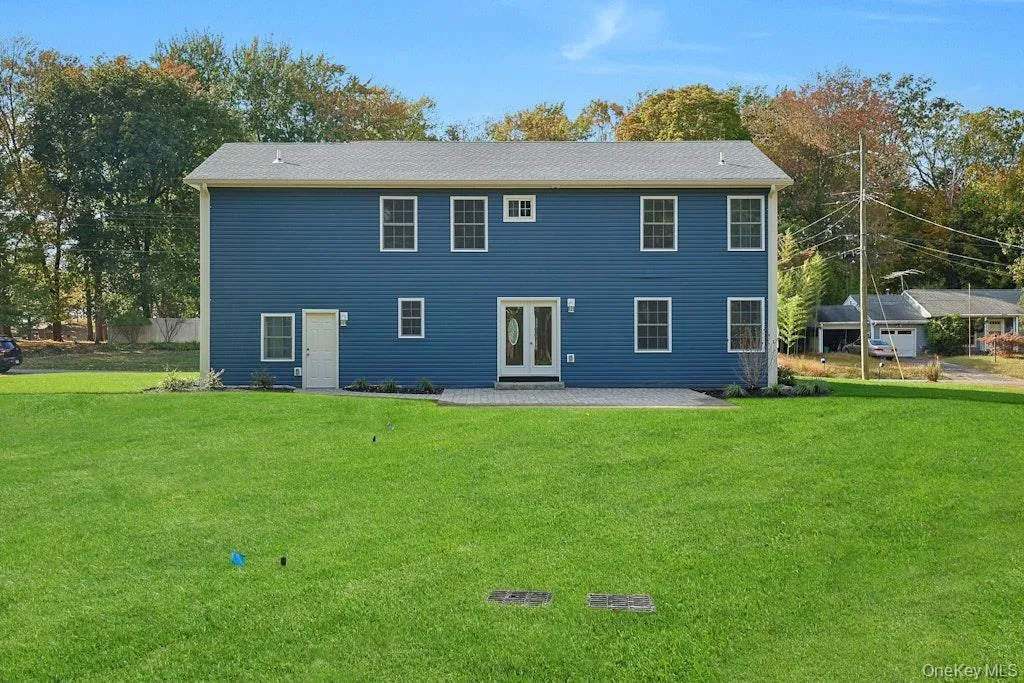 Back of property with a patio area and a lawn Back of property with a patio area and a lawn