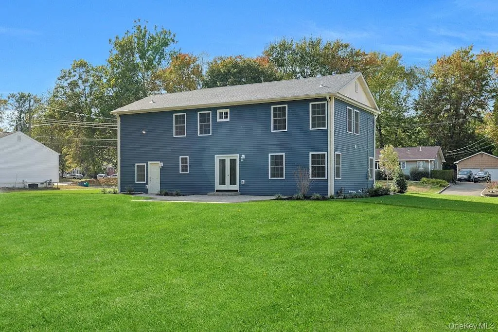 Rear view of property featuring a patio area and a yard Rear view of property featuring a patio area and a yard