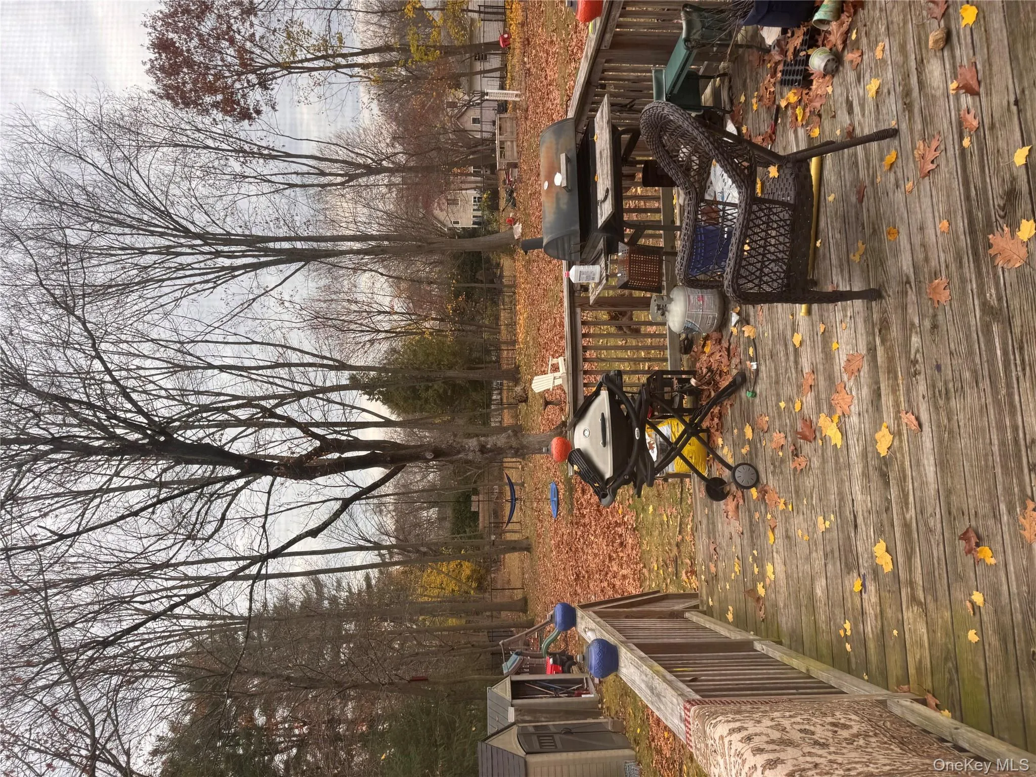 Wooden terrace featuring a storage shed and area for grilling Wooden terrace featuring a storage shed and area for grilling