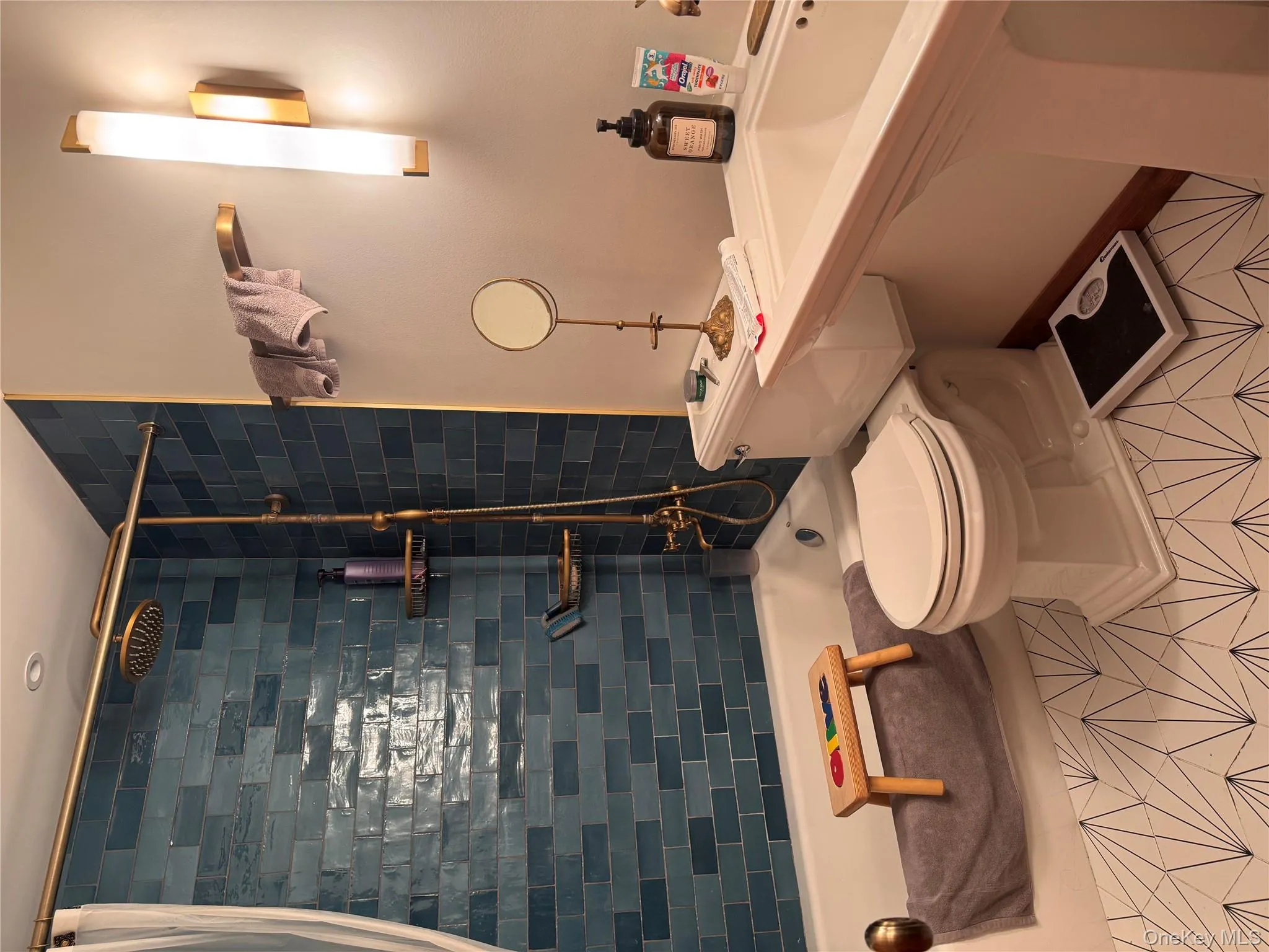 Bathroom with shower / bath combination with curtain and tile patterned flooring Bathroom with shower / bath combination with curtain and tile patterned flooring