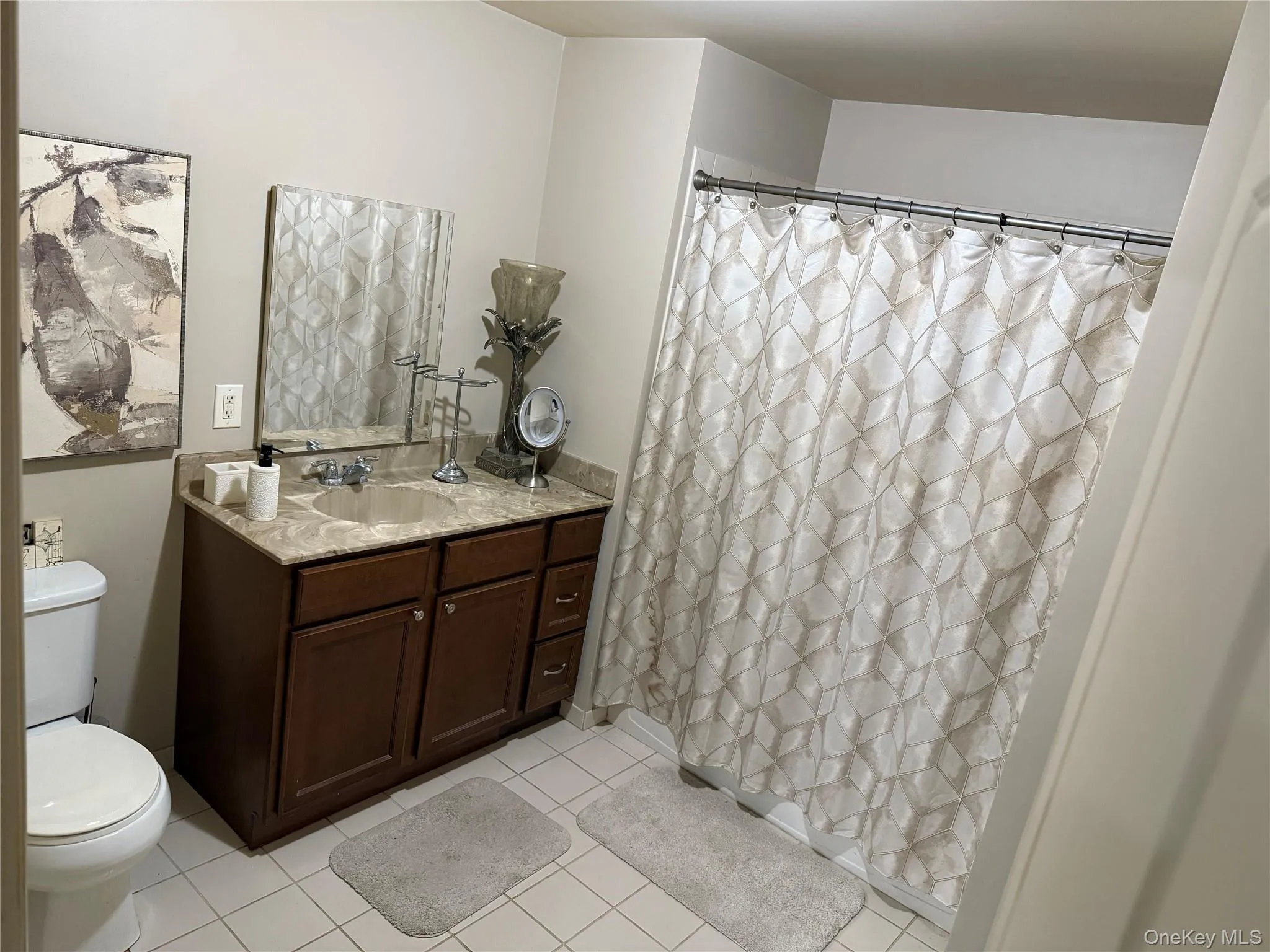 Master Bathroom with vanity, curtained shower, and light tile patterned floors. Master Bathroom with vanity, curtained shower, and light tile patterned floors.