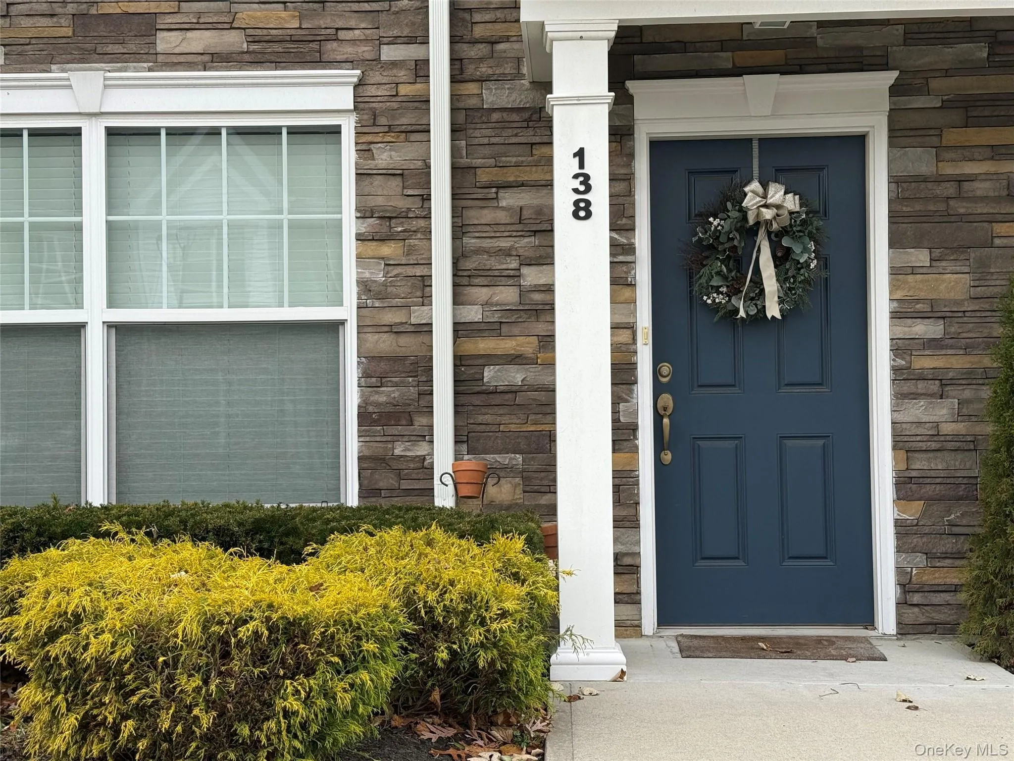 Property entrance featuring stone siding. Property entrance featuring stone siding.