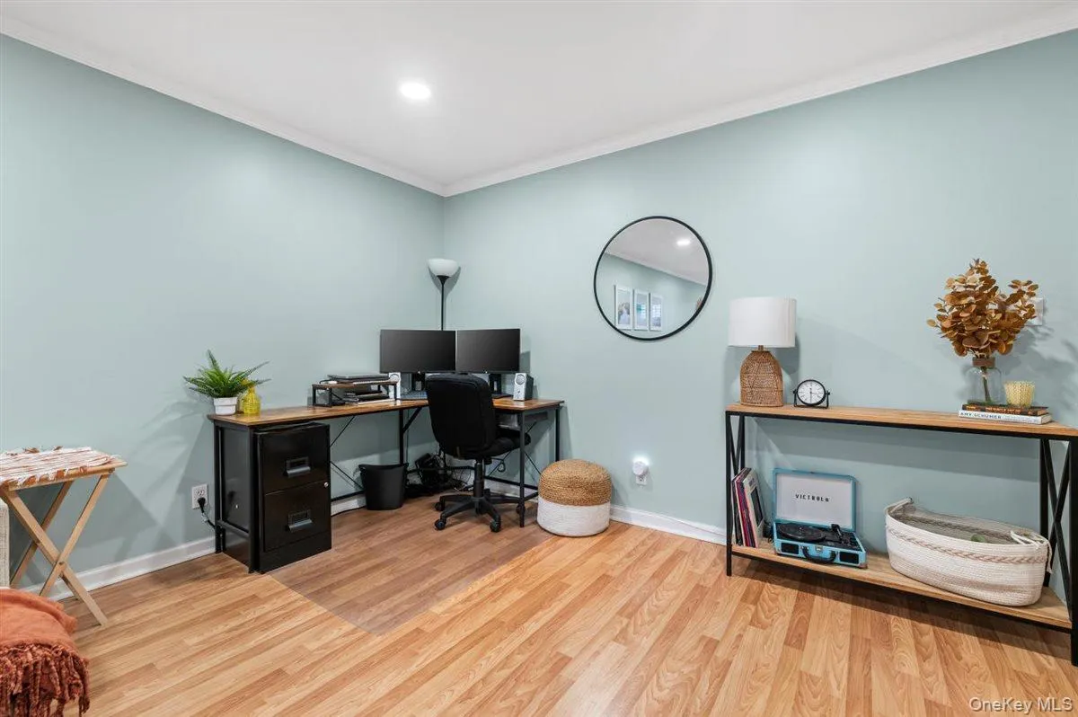 Office area with wood finished floors, ornamental molding, and recessed lighting Office area with wood finished floors, ornamental molding, and recessed lighting