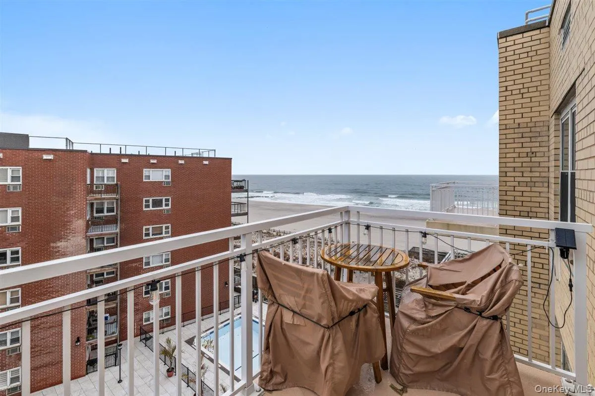 Balcony with grilling area and view of water and beach Balcony with grilling area and view of water and beach