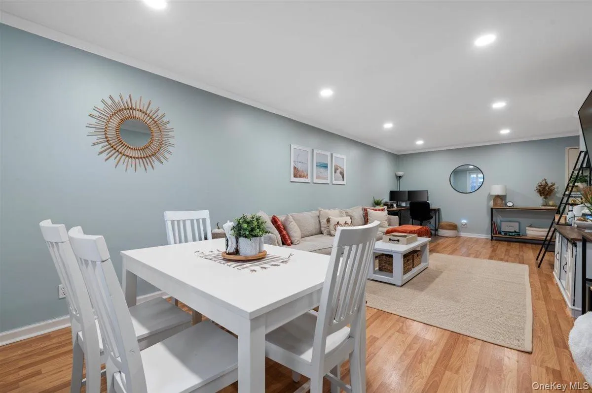 Dining area featuring recessed lighting, ornamental molding, and light wood-type flooring Dining area featuring recessed lighting, ornamental molding, and light wood-type flooring