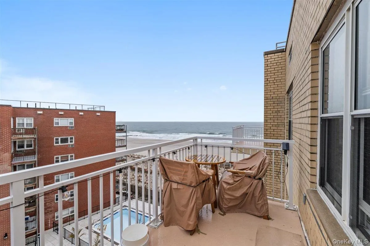 Balcony featuring view of pool and a water view Balcony featuring view of pool and a water view