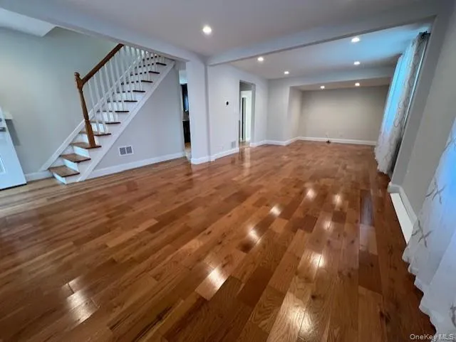 Open Floor Plan LR/DR with wood-type flooring, stairs, and recessed lighting Open Floor Plan LR/DR with wood-type flooring, stairs, and recessed lighting