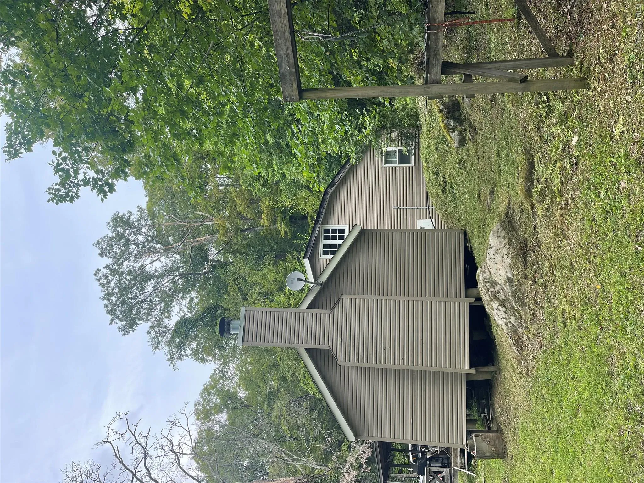 View of side of home with a chimney and a lawn View of side of home with a chimney and a lawn
