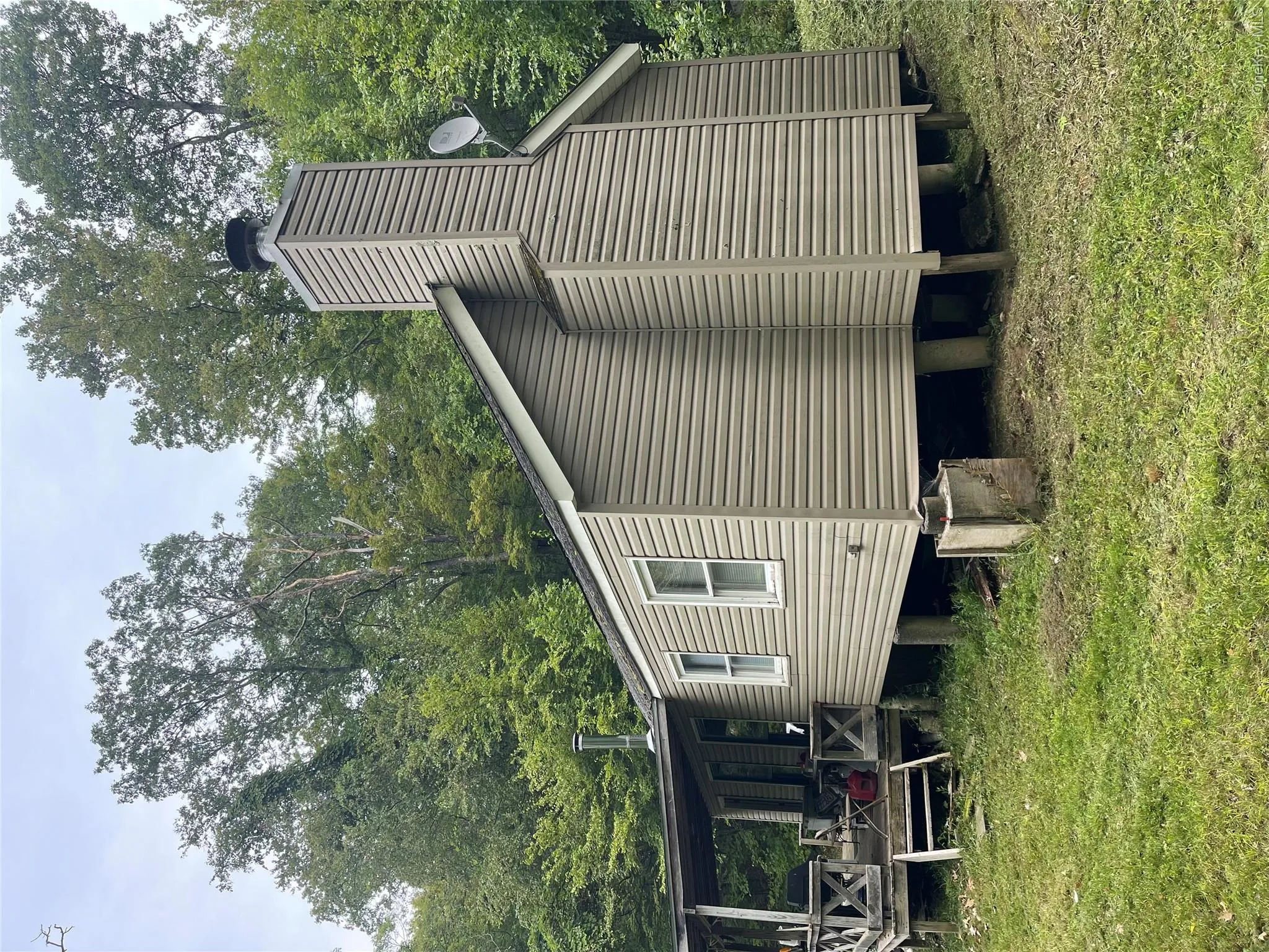 View of property exterior featuring a lawn and a chimney View of property exterior featuring a lawn and a chimney