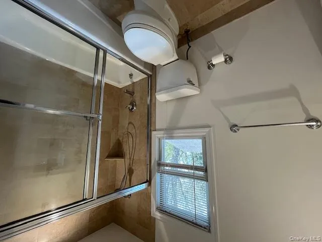 Full bathroom with toilet and shower / bath combination with glass door Full bathroom with toilet and shower / bath combination with glass door