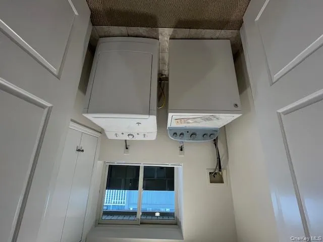 Laundry area featuring washing machine and dryer and light tile patterned floors Laundry area featuring washing machine and dryer and light tile patterned floors