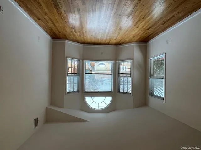 Spare room featuring lofted ceiling and light wood finished floors Spare room featuring lofted ceiling and light wood finished floors