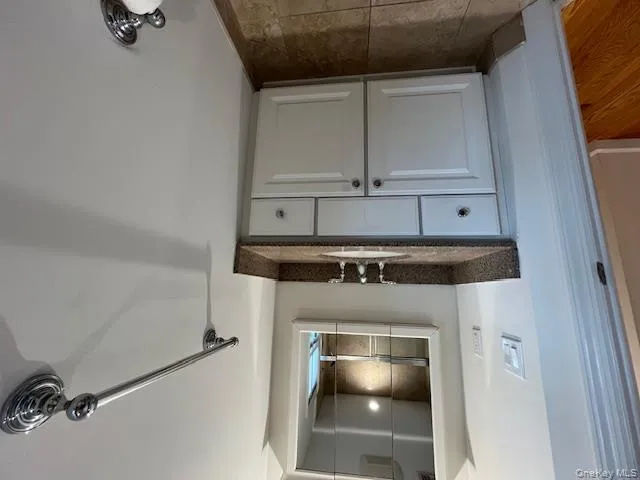 Bathroom with vanity and a shower with door Bathroom with vanity and a shower with door