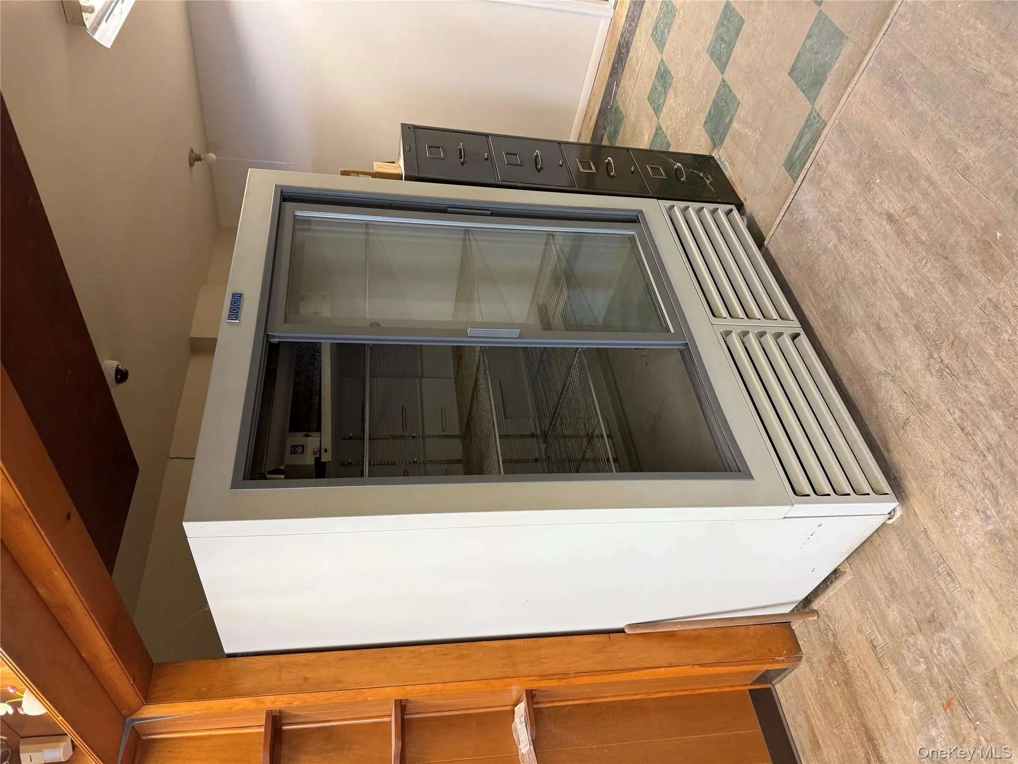 Detailed view of beverage cooler and wood finished floors Detailed view of beverage cooler and wood finished floors