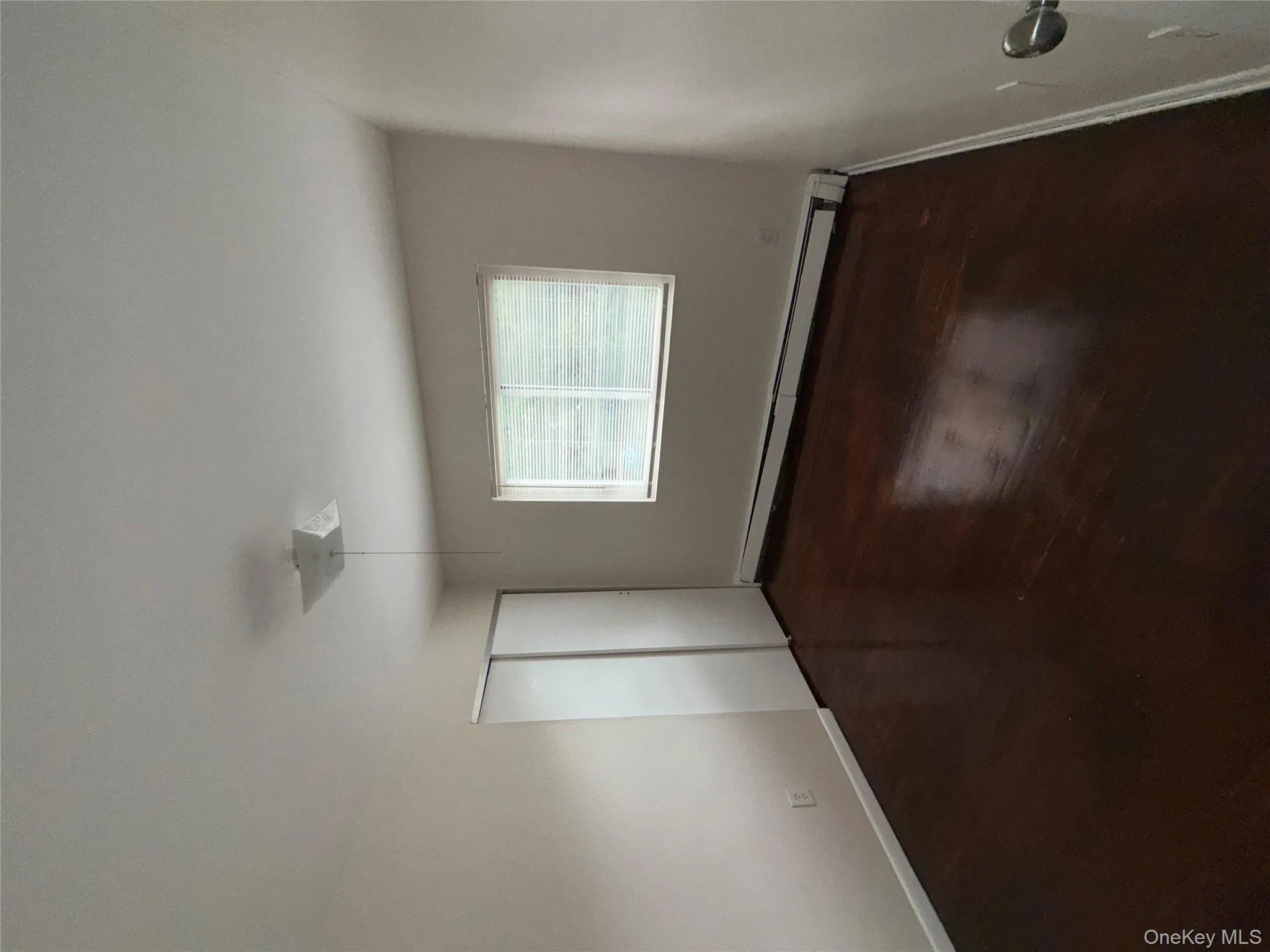 Unfurnished bedroom featuring a baseboard radiator, a closet, ceiling fan, and dark wood-style flooring Unfurnished bedroom featuring a baseboard radiator, a closet, ceiling fan, and dark wood-style flooring